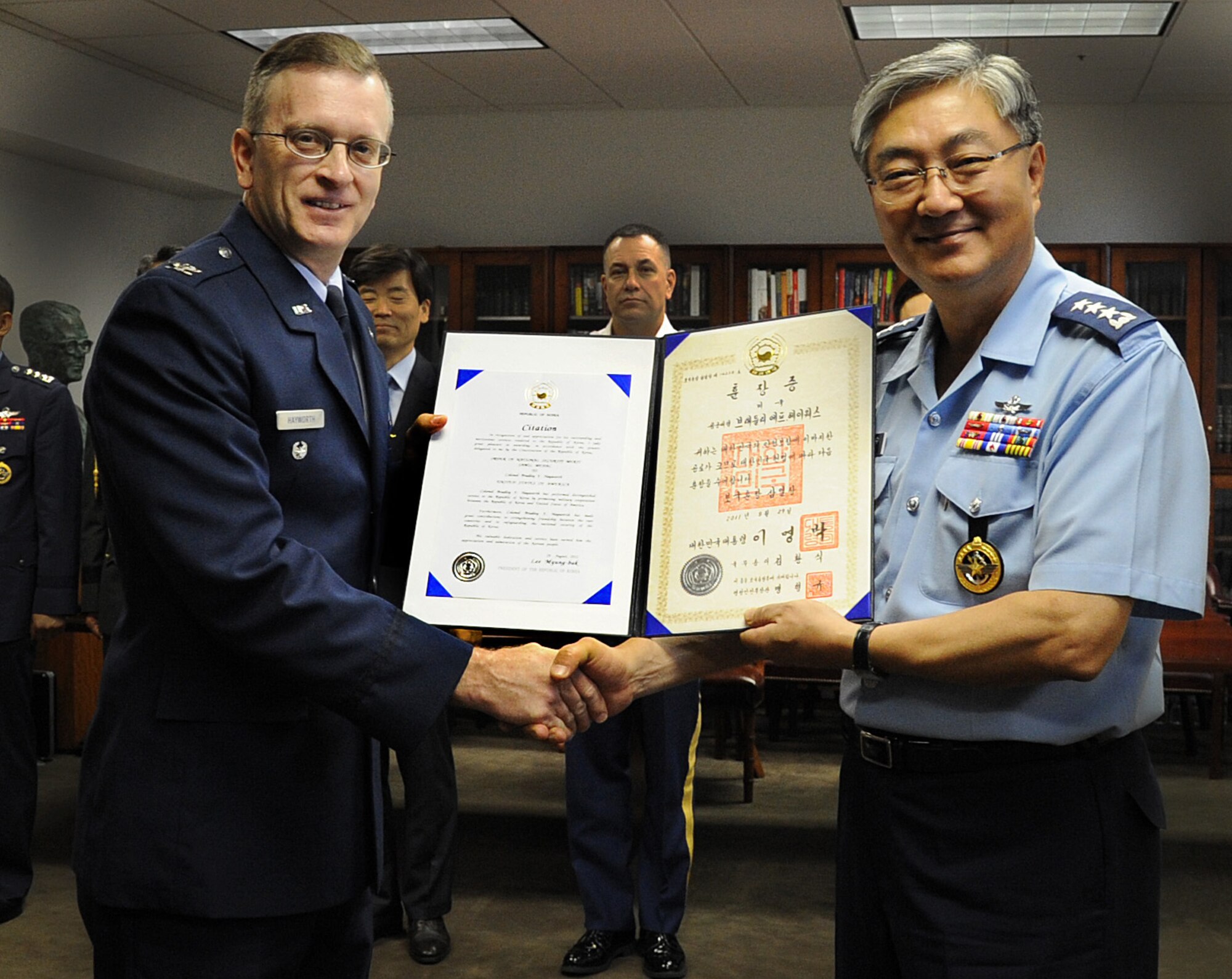 WASHINGTON, D.C. -- Col. Bradley Hayworth, is presented the Order of National Security Merit, also known as the Samil Medal, by Lt. Gen. Yoon Hak Soo, director of Korea Defense Intelligence Agency, at the Embassy of the Republic of Korea here Sept. 13, 2011. (U.S. Air Force photo/Staff Sgt. Tiffany Trojca)
