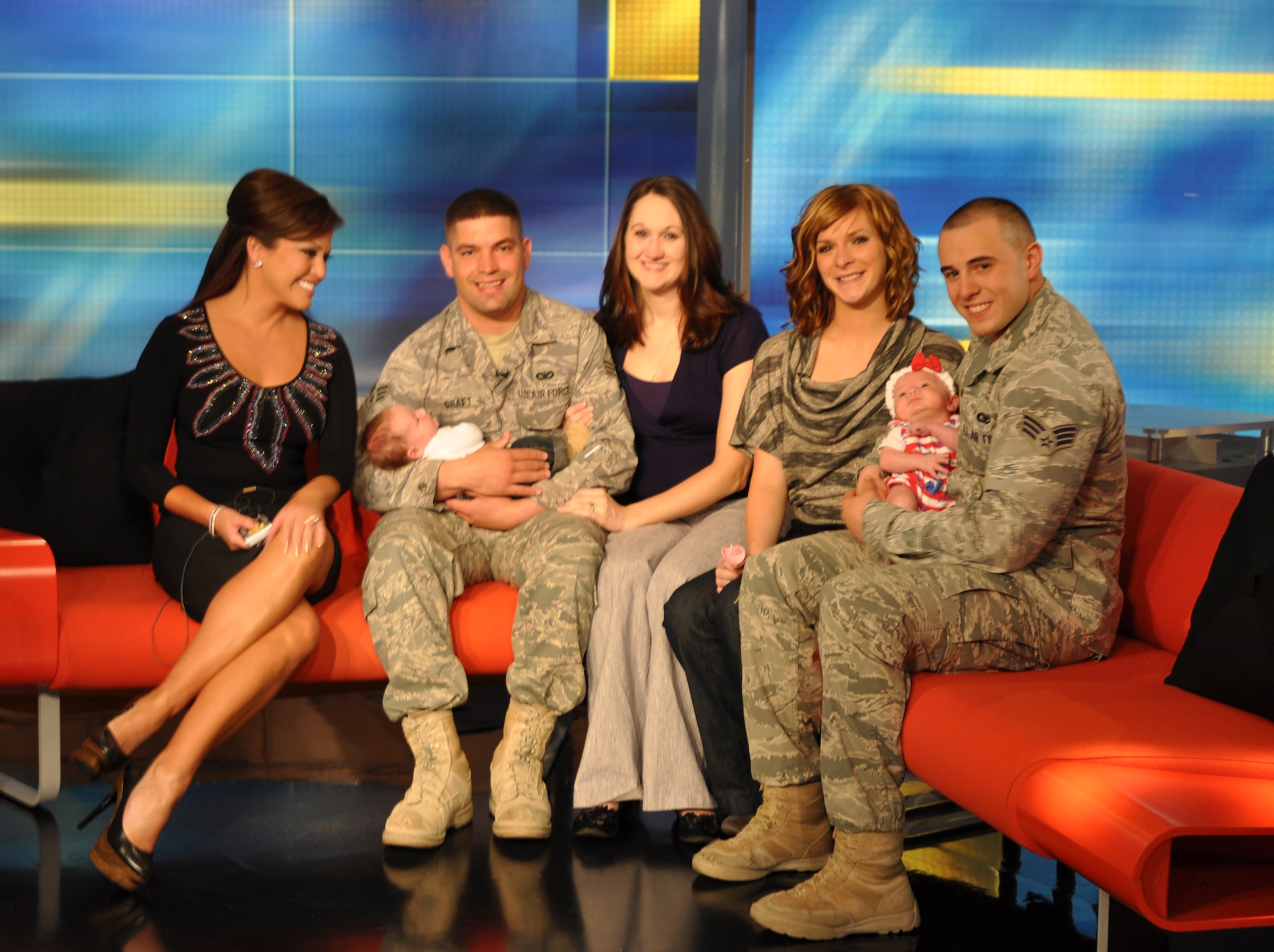 Robin Meade with Air Force Reserve Senior Airman Keith and Lauren Graft and son, Blake, and Senior Airman Domenic and Katlyn Mash and daughter Savannah on the set of the "HLN's Morning Express with Robin Meade" show. The Airmen surprised their wives Sept. 14 during a live "Salute to the Troops" segment. Katlyn and Lauren gave birth to their children in August while their husbands were deployed to Afghanistan.  (U.S. Air Force photo/Chief Master Sgt. Bill Goben)