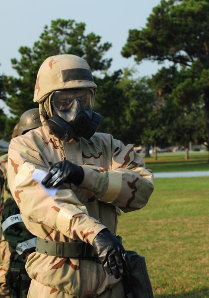 U.S. Air Force Airman 1st Class Paul Francis, 23rd Wing public affairs photographer, simulates using a M295 decontamination kit during a contamination control area attendant training, at Moody Air Force Base, Ga., Sept. 14, 2011. The M295 decontamination kit allows airman to decontaminate their individual equipment by physical removal and absorbing chemical agents. (U.S. Air Force photo by Senior Airman Stephanie Mancha/Released)