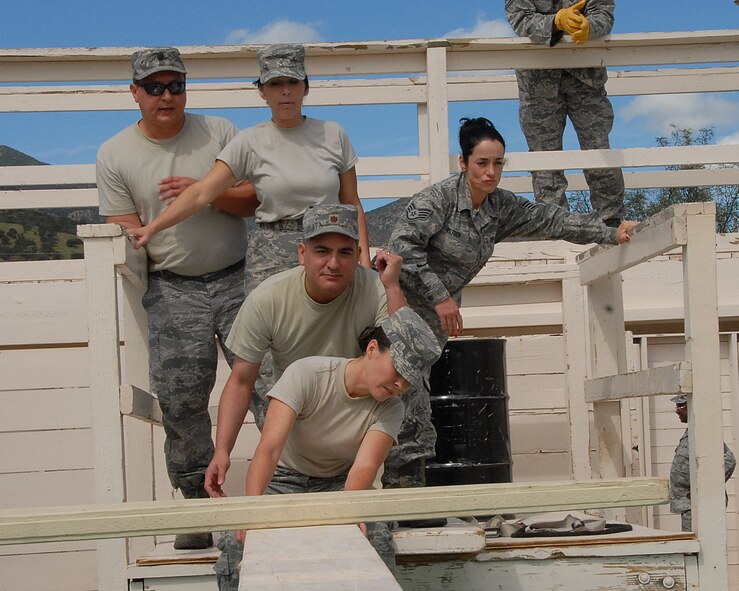 Members of the 162nd Fighter Wing Headquarters Squadron negotiate one of several obstacles presented during the Leadership Reaction Course.  (U.S. Air Force photo/Staff Sgt. Mike Whitt)