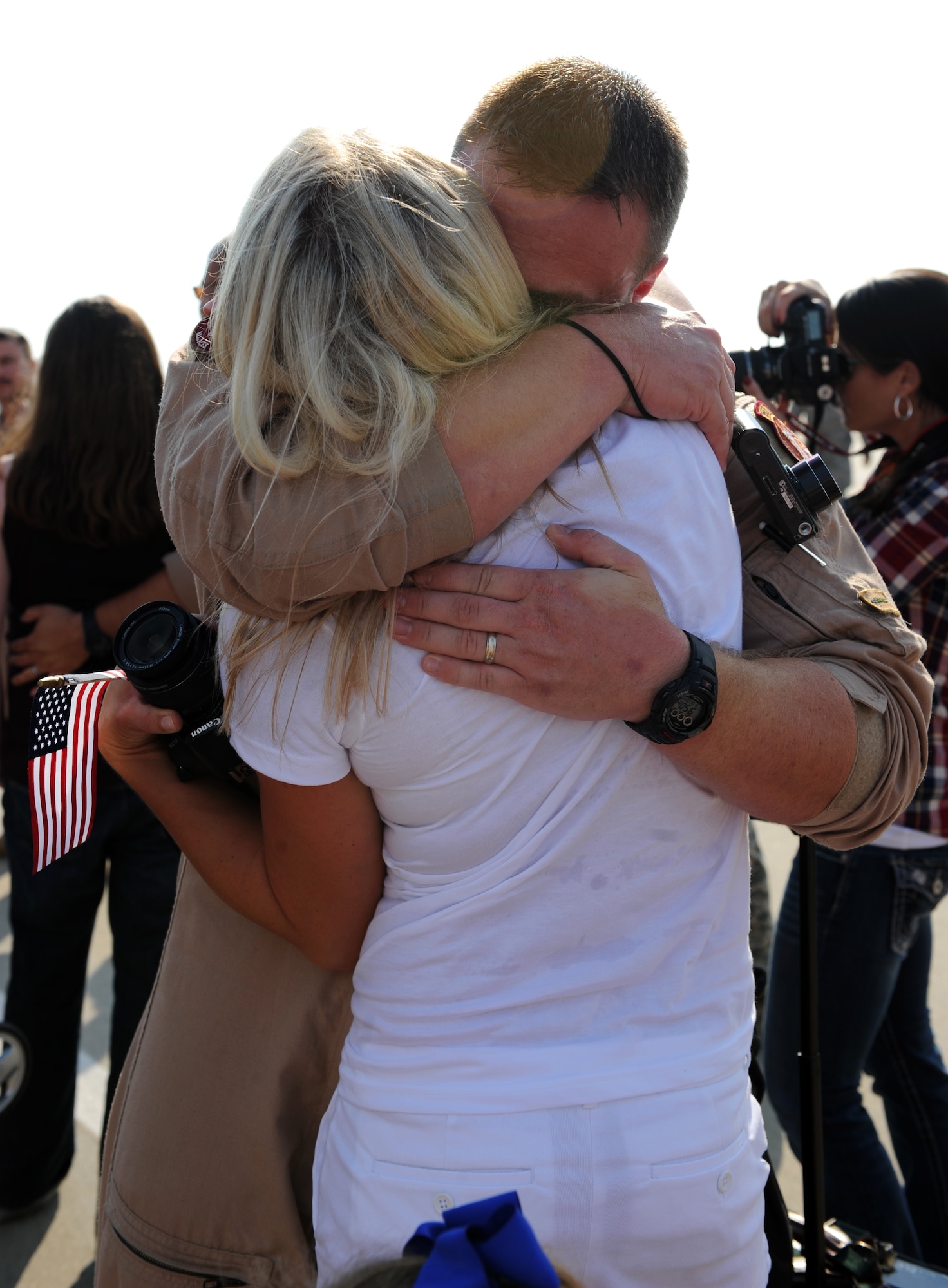 U.S. Air Force Capt. Ryan Wilmes, 77th Fighter Squadron F-16 Fighting Falcon pilot, holds his wife Lisa Wilmes at Shaw Air Force Base, S.C. Sept. 14, 2011. The 77th Fighter Squadron returned from a five month deployment after providing air suppression and destruction of enemy defenses in support of Operation Unified Protector. (U.S. Air Force photo by Airman 1st Class Tabatha Duarte/Released)
