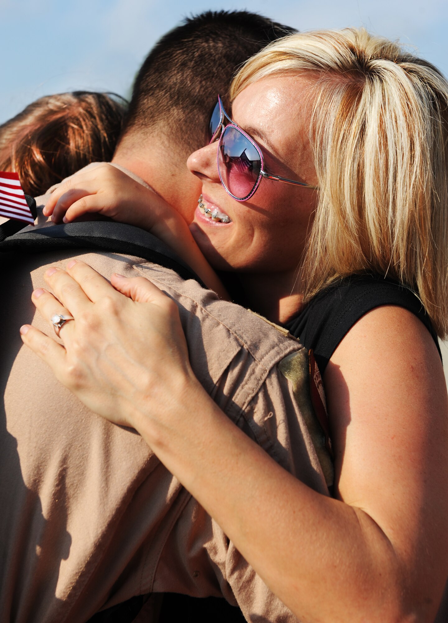 U.S. Air Force Capt. John Pegg, 77th Fighter Squadron F-16 Fighting Falcon pilot, hugs his wife Cassie Pegg and daughter Ella Pegg, Shaw Air Force Base, S.C.,Sept. 14, 2011. The 77th Fighter Squadron returned from a five month deployment after providing air suppression and destruction of enemy defenses in support of Operation Unified Protector. (U.S. Air Force photo by Airman 1st Class Tabatha Duarte/Released)