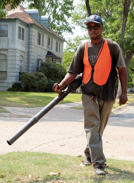 Ivory Horton, a contracted worker, blows leaves off a sidewalk on Barksdale Air Force Base, La., Sept. 14. Barksdale contracts many different companies to do lawn and construction work around base. (U.S. Air Force photo/Airman 1st Class Benjamin Gonsier)(RELEASED)
