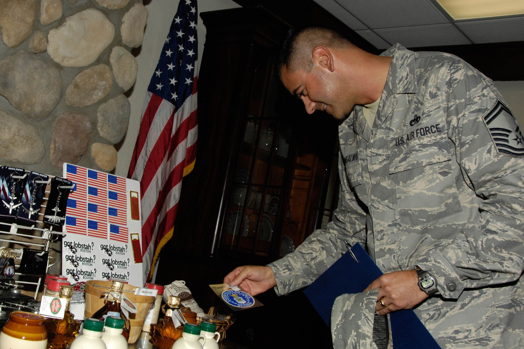 HANSCOM AIR FORCE BASE, Mass. – Senior Master Sgt. Donald Gonsalves checks out some of the items for sale in the Tickets and Tours gift shop during the Minuteman Commons grand opening Sept. 8. As part of the community center transformation, Tickets and Tours moved to the old dining room. (U.S. Air Force photo by Linda LaBonte Britt)