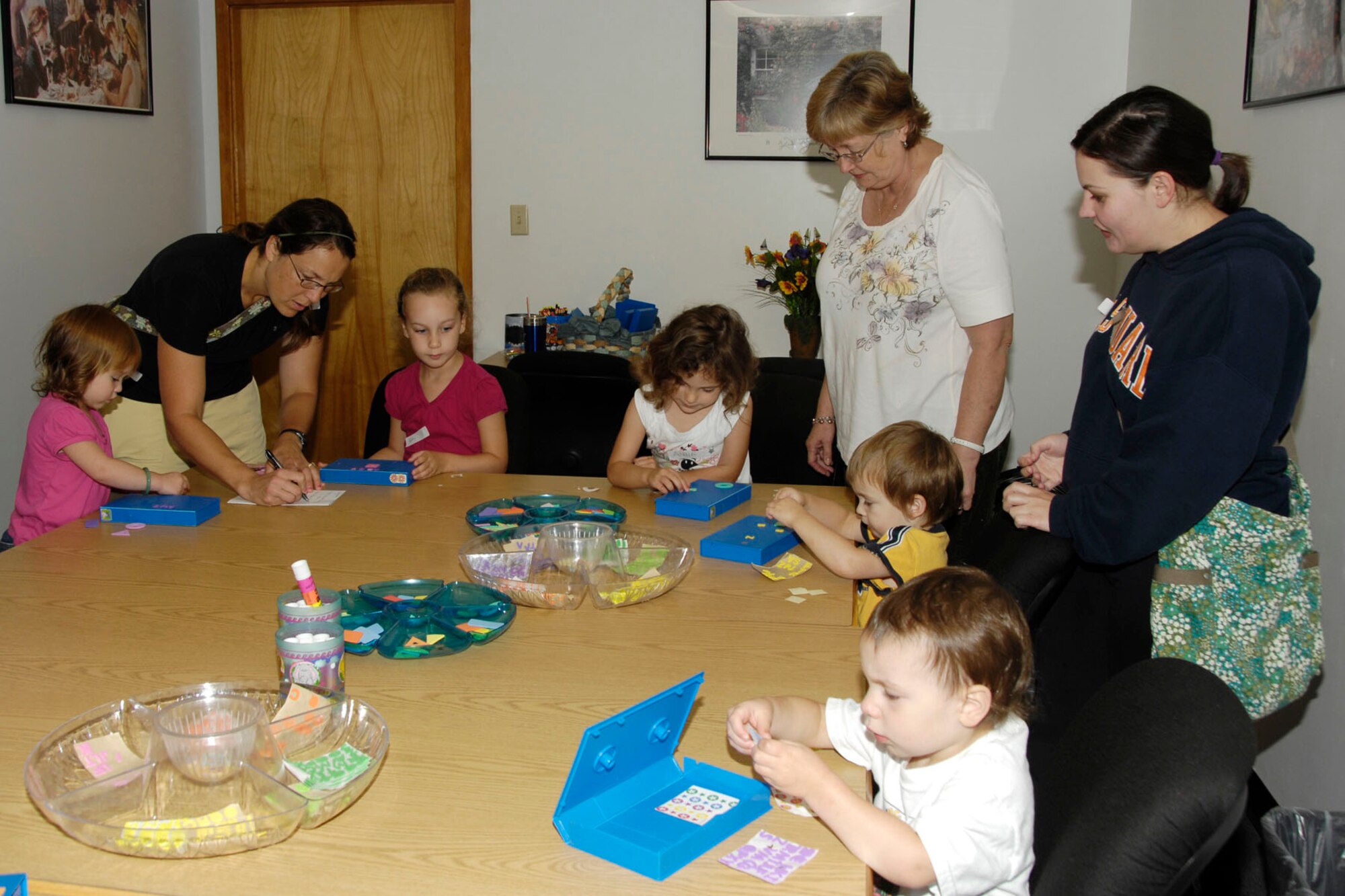 HANSCOM AIR FORCE BASE, Mass. – Preschoolers and parents have fun making crafts after listening to a story during Preschool Story Time at the base library Sept. 7. The library's next Preschool Story Times will take place Sept. 21 and 28 from 10:15 to 11 a.m. U.S. Air Force photo by Linda LaBonte Britt)