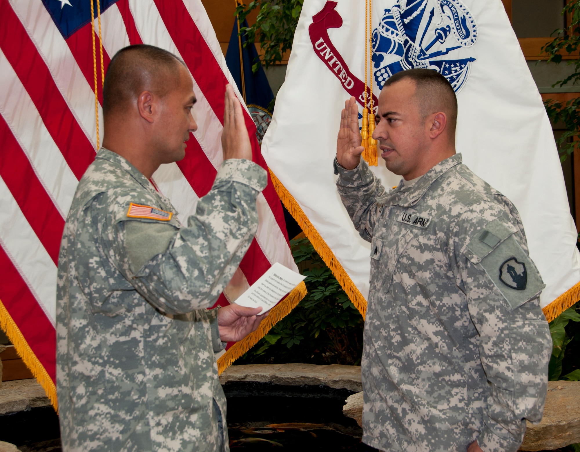 Army Liaison Sgt. Luis Irizarry recites the oath of enlistment in a ceremony presided by Lt. Col. Michael Cepe Sept. 9, 2011 at the Charles C. Carson Center for Mortuary Affairs at Dover Air Force Base, Del. Irizarry is a mortuary affairs specialist deployed from the 311th Quartermaster Company in Puerto Rico, and assigned here under the Casualty and Mortuary Affairs Operations Center, U.S. Army Human Resources Command, located at Fort Knox, Ky. (U.S. Air Force Photo/Staff Sgt. Agustin Salazar)
