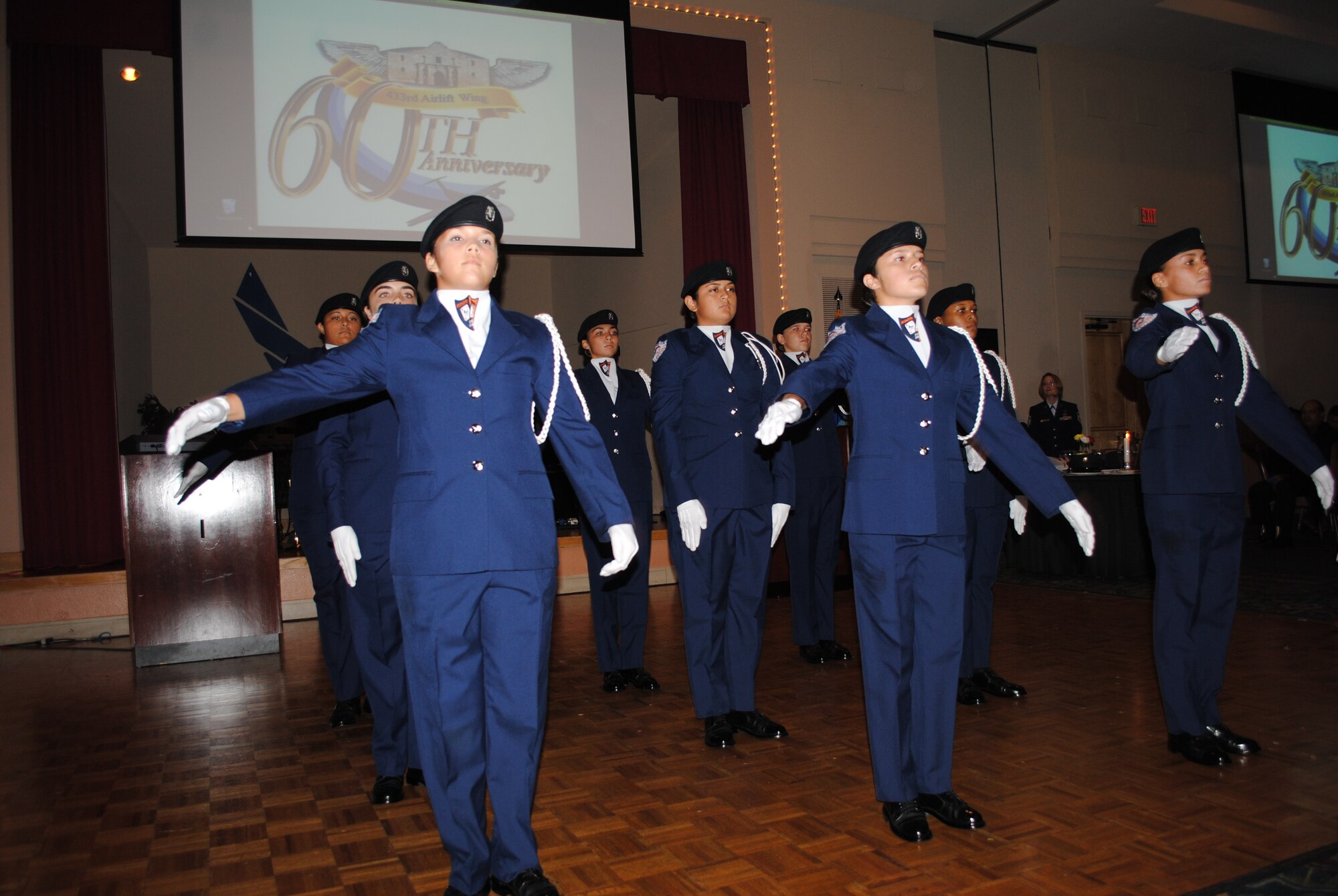 Brandeis High School unarmed, all-female Air Force Junior ROTC drill team, the Blue Aces, treat guests to a  precious military drill demonstration during the 433rd Airlift Wing 60th Anniversary Dinner held Sept. 10, 2011, at the Gateway Club on Lackland Air Force Base, Texas. Local San Antonio area group received a standing ovation.  (U.S. Air Force photo/Senior Airman Luis Loza Gutierrez)