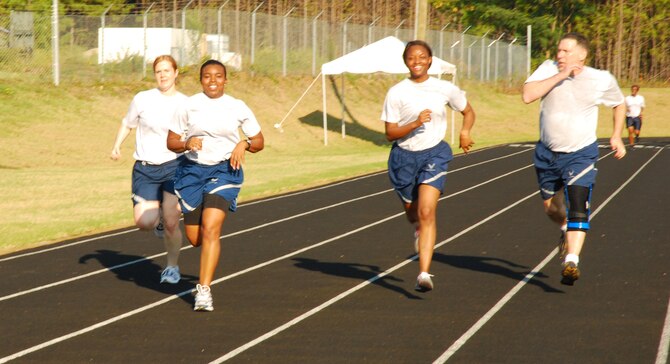 Servicemembers complete the 400 meter sprint in conclusion to the aerobic component of the Fit Camp held Sept. 14. Participants completed three rounds of gauntlet circuit training, an 800-meter run and a 400-meter walk/sprint during fit camp training held weekly at the base running track. (U.S. Air Force photo/Airman 1st Class Chelsea Smith)