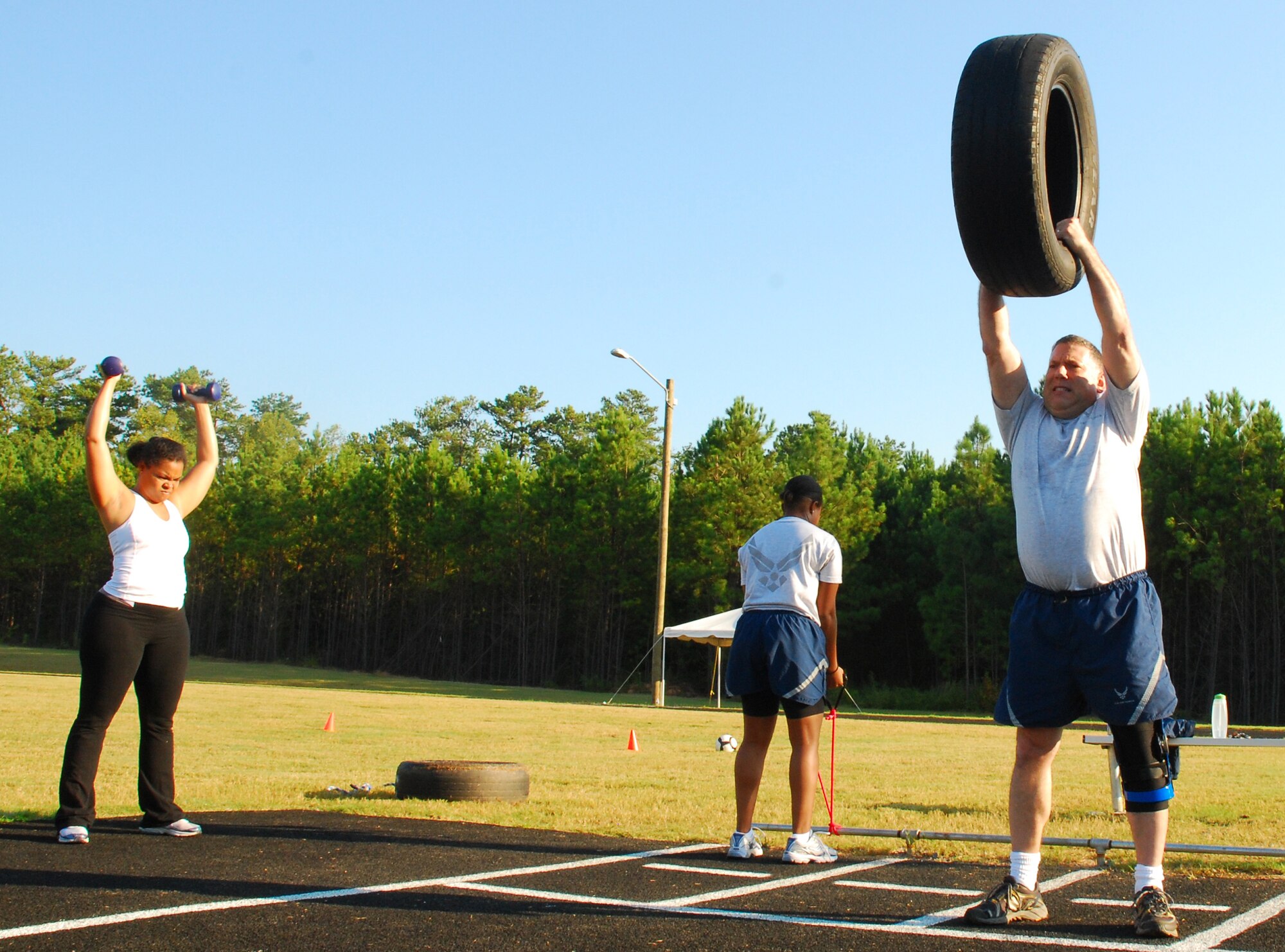 Participants of the fit camp held Sept. 14 complete various circuit training exercises during the hour-long session held at the base running track.