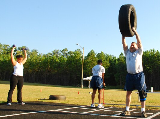 Participants of the fit camp held Sept. 14 complete various circuit training exercises during the hour-long session held at the base running track. (U.S. Air Force photo/Airman 1st Class Chelsea Smith)