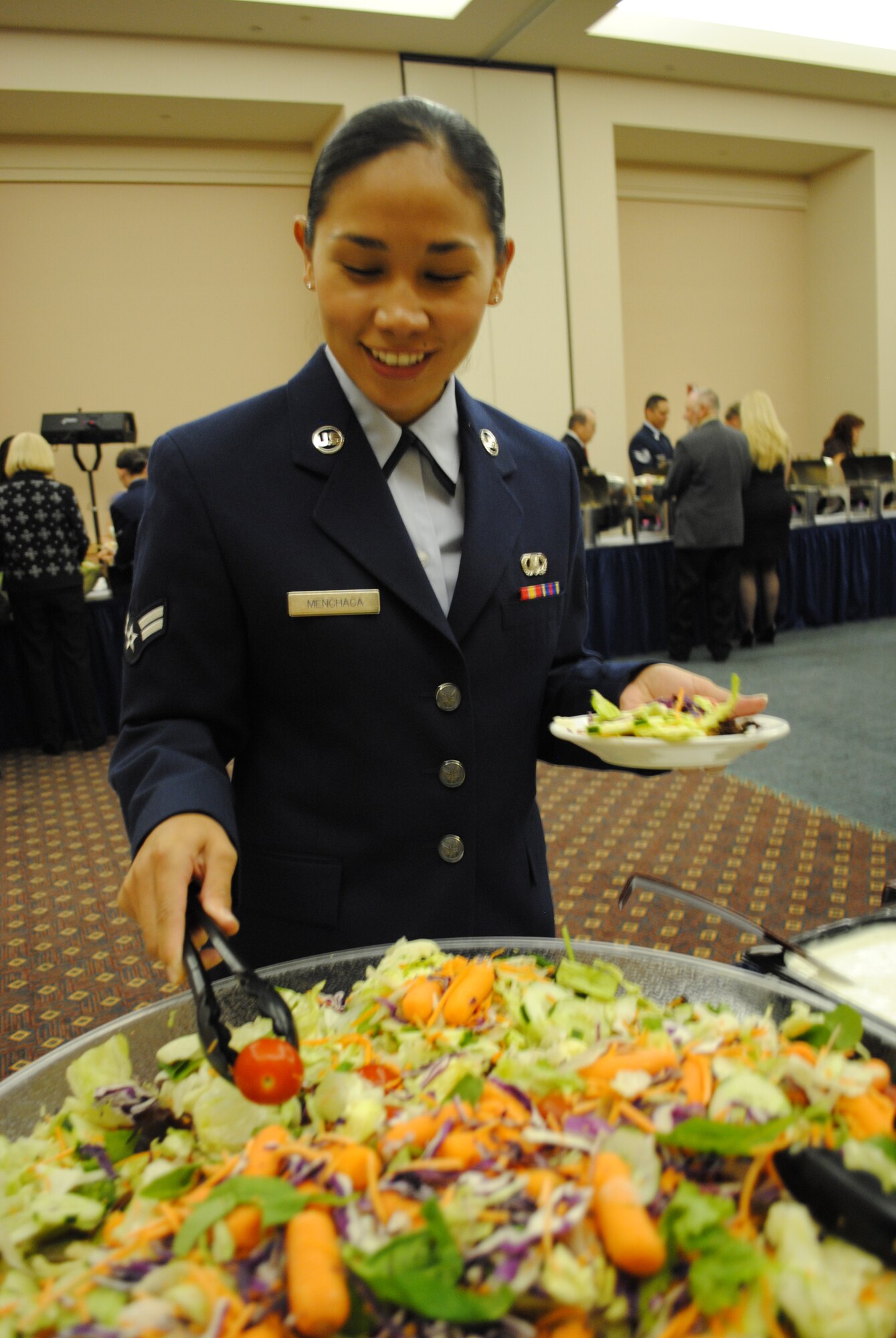 Airman 1st Class Katherine Menchaca from the 433rd Operational Support Squadron, prepares a personal salad during the 433rd Airlift Wing 60th Anniversary Dinner held Sept. 10, 2011, at the Gateway Club on Lackland Air Force Base, Texas. Gateway Club Executive Chef Lazaro Carrazco and his team of three cooks prepared a buffet-style meal for more than 475 guests in less than 24 hours. The meal included options such as glazed pork loin, chicken with a sage and white wine sauce, chocolate mousse, steamed vegetable medley and apple cobbler. (U.S. Air Force photo/Senior Airman Luis Loza Gutierrez)