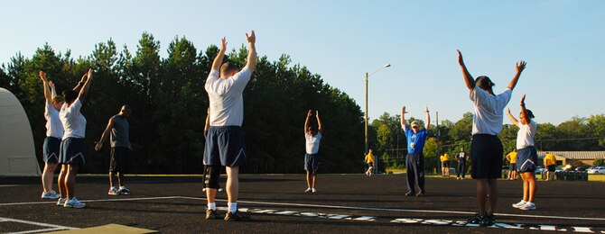 Members from Dobbins perform warm-up stretches in preparation for fit camp held at the running track here Sept. 14. The boot-camp type training is conducted for Dobbins servicemembers during the week rotating between aerobic and anaerobic exercises. (U.S. Air Force photo/Airman 1st Class Chelsea Smith)