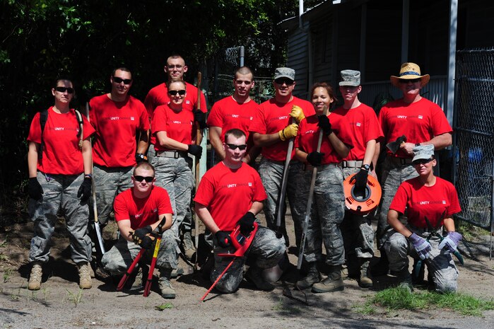 Members of the 437th Aerial Port Squadron pose for a photo after volunteering during National Day of Caring, Sept. 9, 2011, in the East Central neighborhood of Charleston, S.C. More than 200 volunteers participated in 35 projects which included landscaping, debris removal, painting, and light repairs in neighborhoods located in downtown Charleston. Military, DoD civilians, dependents and retirees participated in the community service project. (U.S. Air Force photo/Staff Sgt. Nicole Mickle)