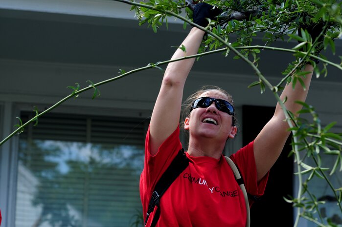 Staff Sgt. Ashley Kelly prunes back branches during National Day of Caring, Sept. 9, 2011, in the East Central neighborhood of Charleston, S.C. More than 200 volunteers participated in 35 projects which included landscaping, debris removal, painting, and light repairs in neighborhoods located in downtown Charleston.  Military, DoD civilians, dependents and retirees participated in the community service project. Kelley is from the 437th Aerial Port Squadron. (U.S. Air Force photo/Staff Sgt. Nicole Mickle) 