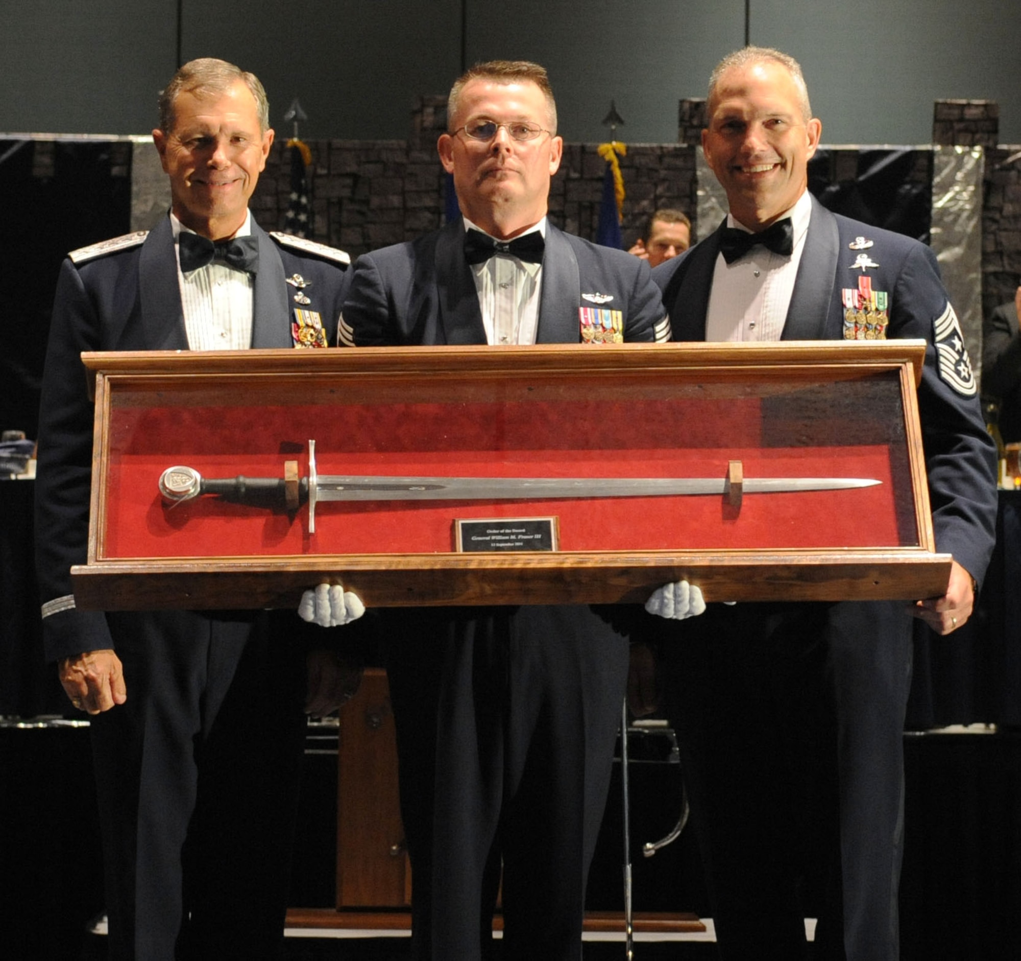 U.S. Air Force Gen. William Fraser III, commander of Air Combat Command, poses with Command Chief Master Sgt’s. Kevin Howell, 633rd Air Base Wing, and Chief Master Sgt. Martin Klukas, ACC, during the Order of the Sword ceremony in Hampton, Va., Sept. 12, 2011. Fraser was recognized for ensuring the Airmen of ACC were properly trained and equipped to complete the mission while taking care of them and their families. (U.S. Air Force photo by Airman 1st Class Racheal Watson/Released)