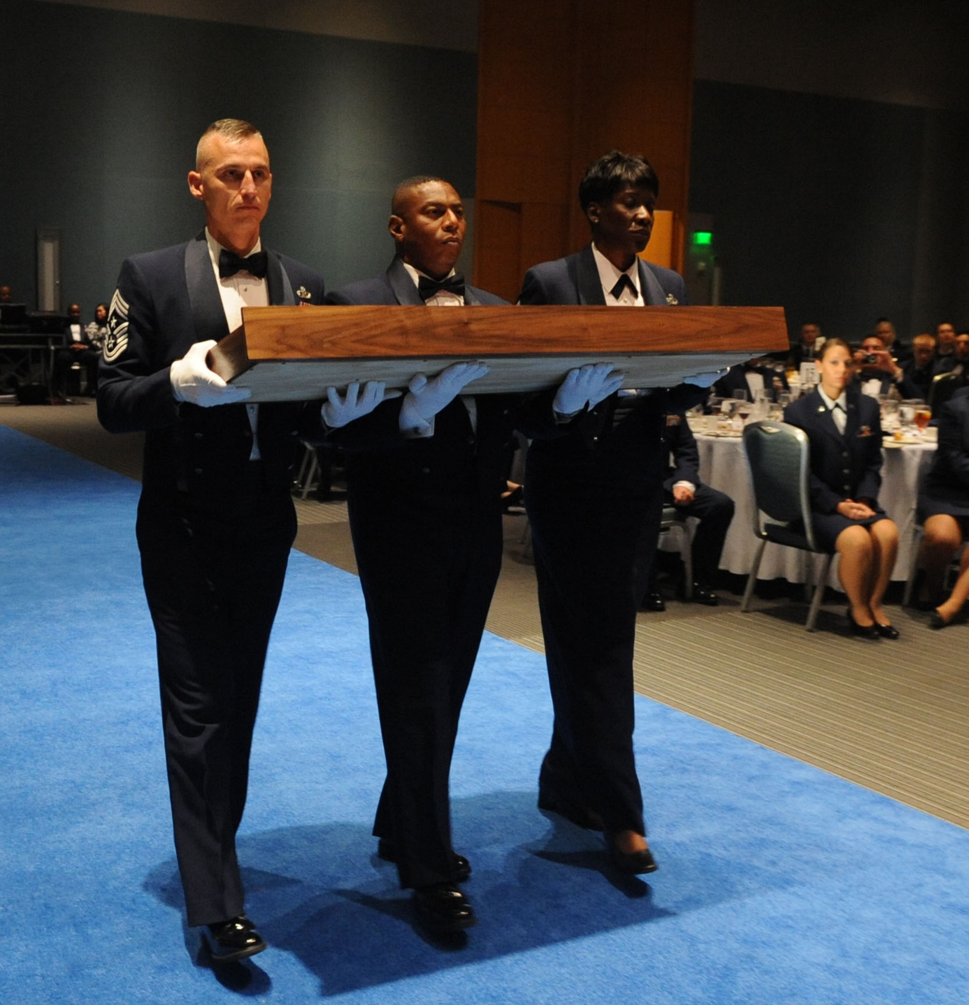U.S. Air Force Command Chief Master Sgts. Michael J. Klintworth, Lorenzo Anastasie, and Chief Master Sgt. Salina James, carry the sword to be presented during the Order of the Sword ceremony in Hampton, Va., Sept. 12, 2011. Gen. William Fraser III, commander of Air Combat Command, was presented the sword, which serves as a symbol of truth, justice and power rightfully used. (U.S. Air Force photo by Airman 1st Class Racheal Watson/Released)