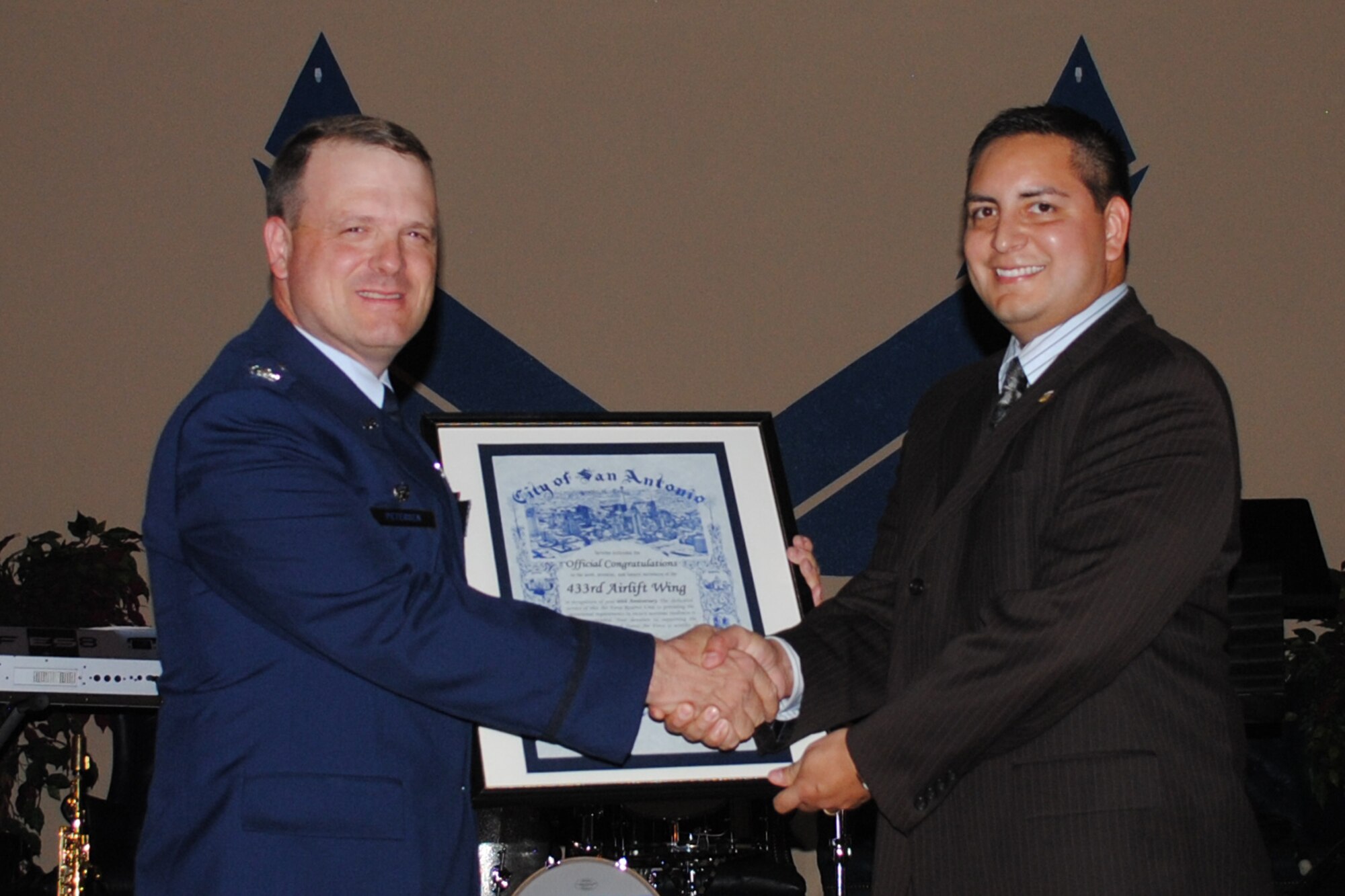 Col. Craig Petersen, 433rd Mission Support Group commander, poses for a photo with Former San Antonio city councilman, Philip Cortez, who presented the Alamo Wing with a congratulatory proclamation by the Honorable Julian Castro, mayor of San Antonio, during the 433rd Airlift Wing 60th Anniversary Dinner, held Sept. 10, 2011, at the Gateway Club on Lackland Air Force Base, Texas. Part of the proclamation read, “The dedicated service of this Air Force Reserve Unit to providing operational requirements is to be commended. Your devotion to supporting the mission of the Air Force is worthy of recognition and praise.” (U.S. Air Force photo/Senior Airman Luis Loza Gutierrez)