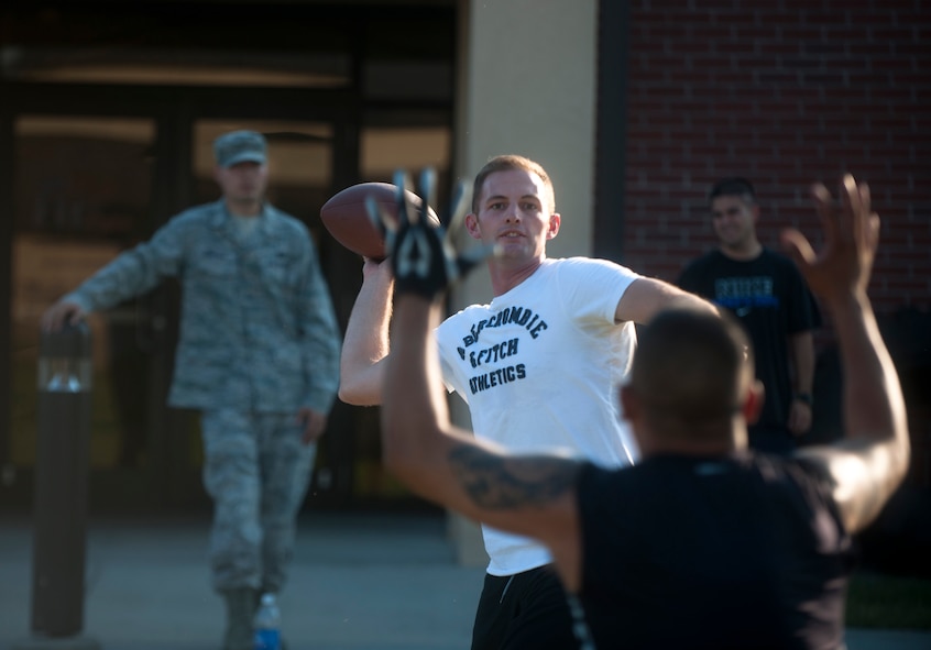 Jordan Brown, the 23rd Wing Staff intramural football team’s quarterback, attempts a pass during the team’s practice at Moody Air Force Base, Ga., Sept. 13, 2011. The 23rd Wing Staff ran plays and drills at practice to determine what position their individuals would be playing. (U.S. Air Force photo by Airman 1st Class Joshua Green/Released)

