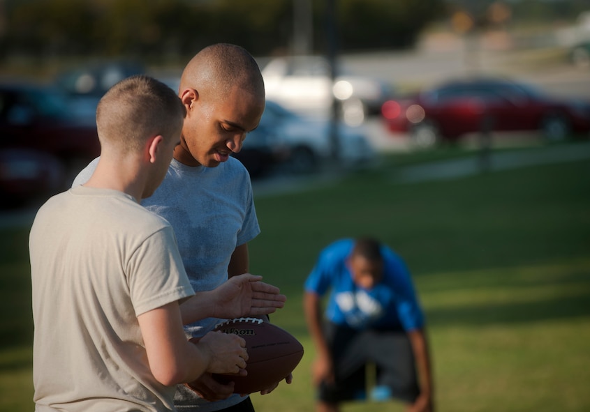 Mark Lawson, a 23rd Wing Staff intramural football team quarterback, discusses a passing route with one of his receivers during a one on one drill while at practice on Moody Air Force Base, Ga., Sept. 13, 2011. A one on one drill consists of offense vs. defense with on individual trying to stop the other from catching the ball. (U.S. Air Force photo by Airman 1st Class Joshua Green/Released)
