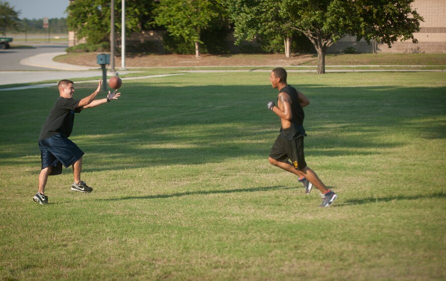 Thomas Hutchins, a 23rd Wing Staff intramural football team wide receiver, catches the ball after he juked a defender during a practice at Moody Air Force Base, Ga., Sept. 13, 2011. The basic rules of flag football are similar to those of the mainstream game but instead of tackling players, the defensive team must remove a flag to end the play. (U.S. Air Force photo by Airman 1st Class Joshua Green/Released)
