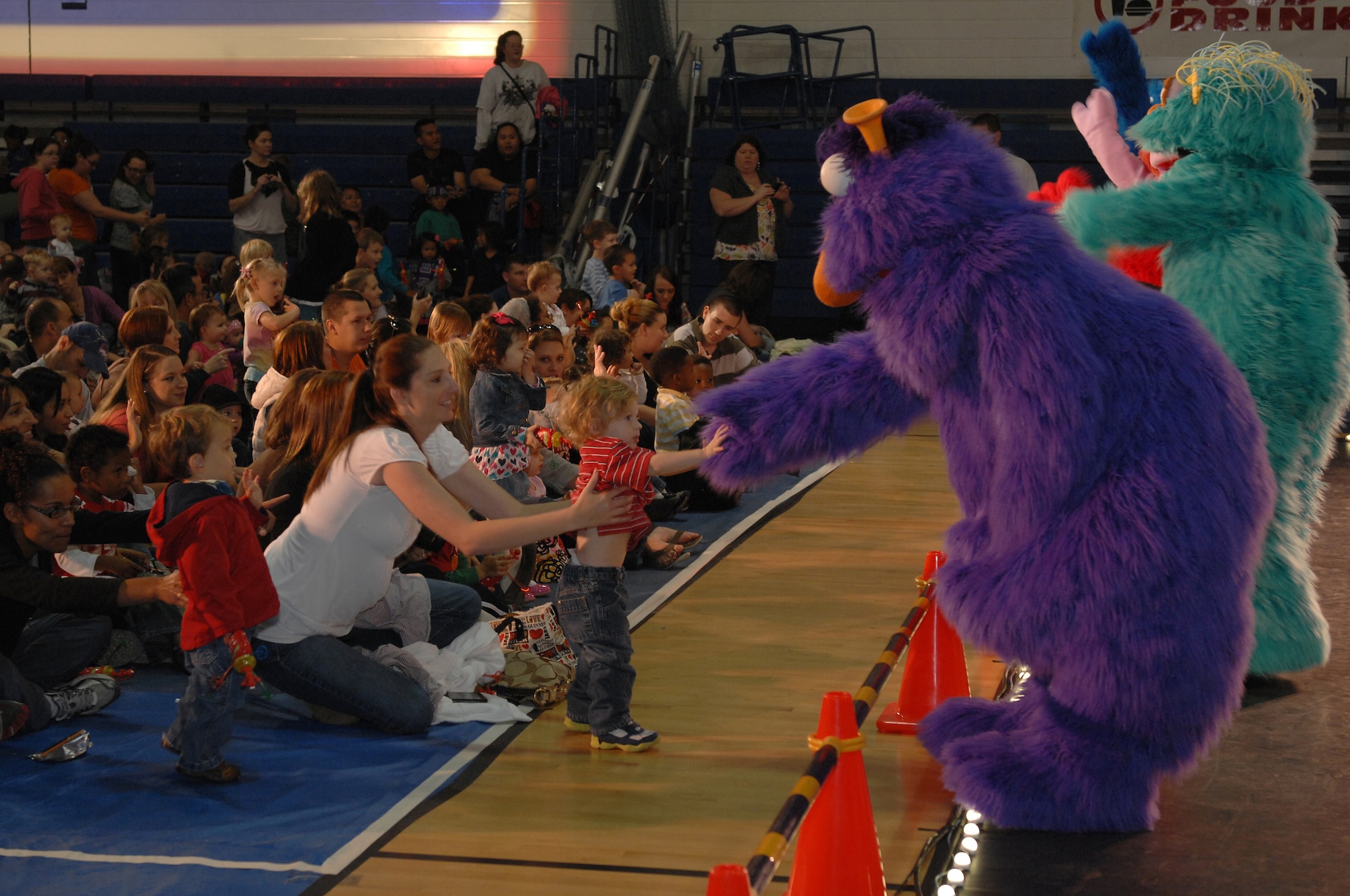 ROYAL AIR FORCE LAKENHEATH, England - 2-year-old Guinness Hagan, son of Senior Airman Daniel Hagan, 48th Munitions Squadron, meets 'Honkers' during the Sesame Street/USO Experience for military families Sept. 13, 2011.  Guinness' mother Casey said he really enjoyed the interaction with the entire group at the first showing.  More than 250 people attended the two shows that featured Katie, a new character who is a military kid that?s moving, and how all her friends could stay in touch.   (U.S. Air Force photo by Tech. Sgt. Lee A. Osberry Jr.)