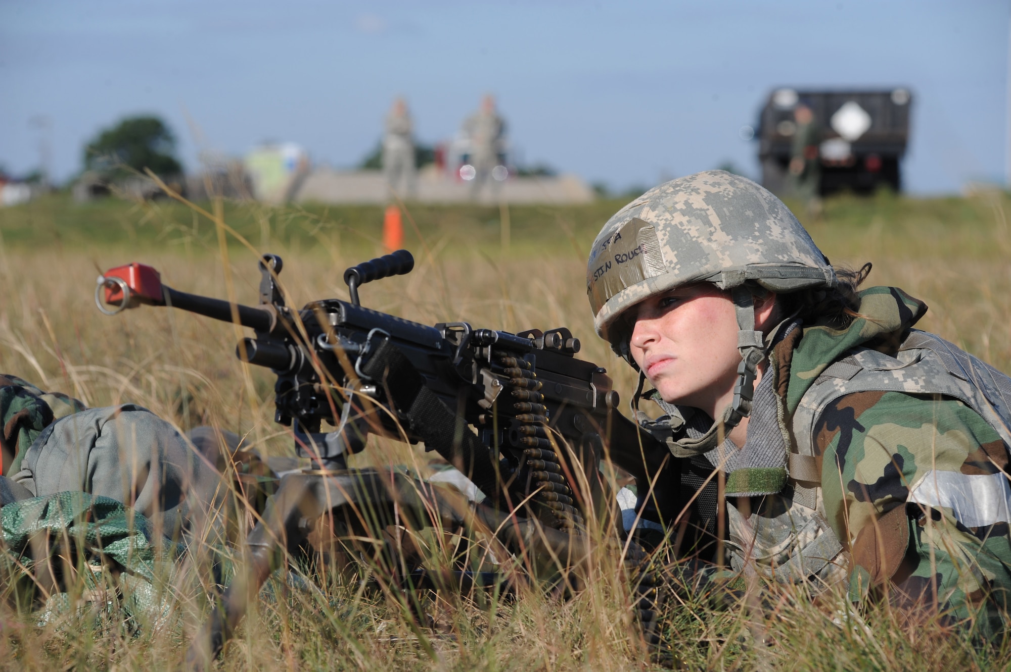 Senior Airman Destin Rouch, a 19th Security Forces Squadron heavy gunner, prepares to fire the M249 light machine gun at a group of simulated armed assailants who attacked a defensive position Sept. 13, 2011, at Volk Field Wis. The 19th SFS Airmen, from Little Rock Air Force Base, Ark., provided base and perimeter security at a simulated bare base, while preparing for an operational readiness inspection in October. (U.S. Air Force photo by Tech. Sgt. Chad Chisholm)