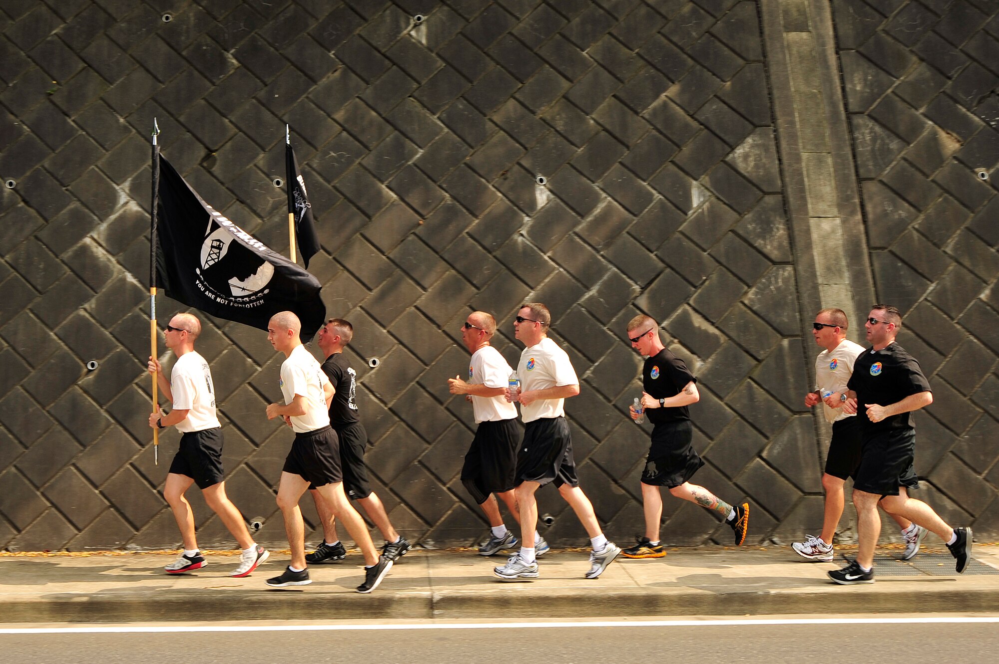 MISAWA AIR BASE, Japan - Members of the 35th Logistics Readiness Squadron honor all Prisoners of War and those Missing in Action during the 35th LRS POW/MIA Run, Sept. 15. Members of the squadron will run the perimeter of the base for 24 hours in remembrance of prior service members who have gone missing in combat and endured enemy prison camps as part of their sacrifice. (U.S. Air Force photo/Staff Sgt. Nathan Lipscomb)