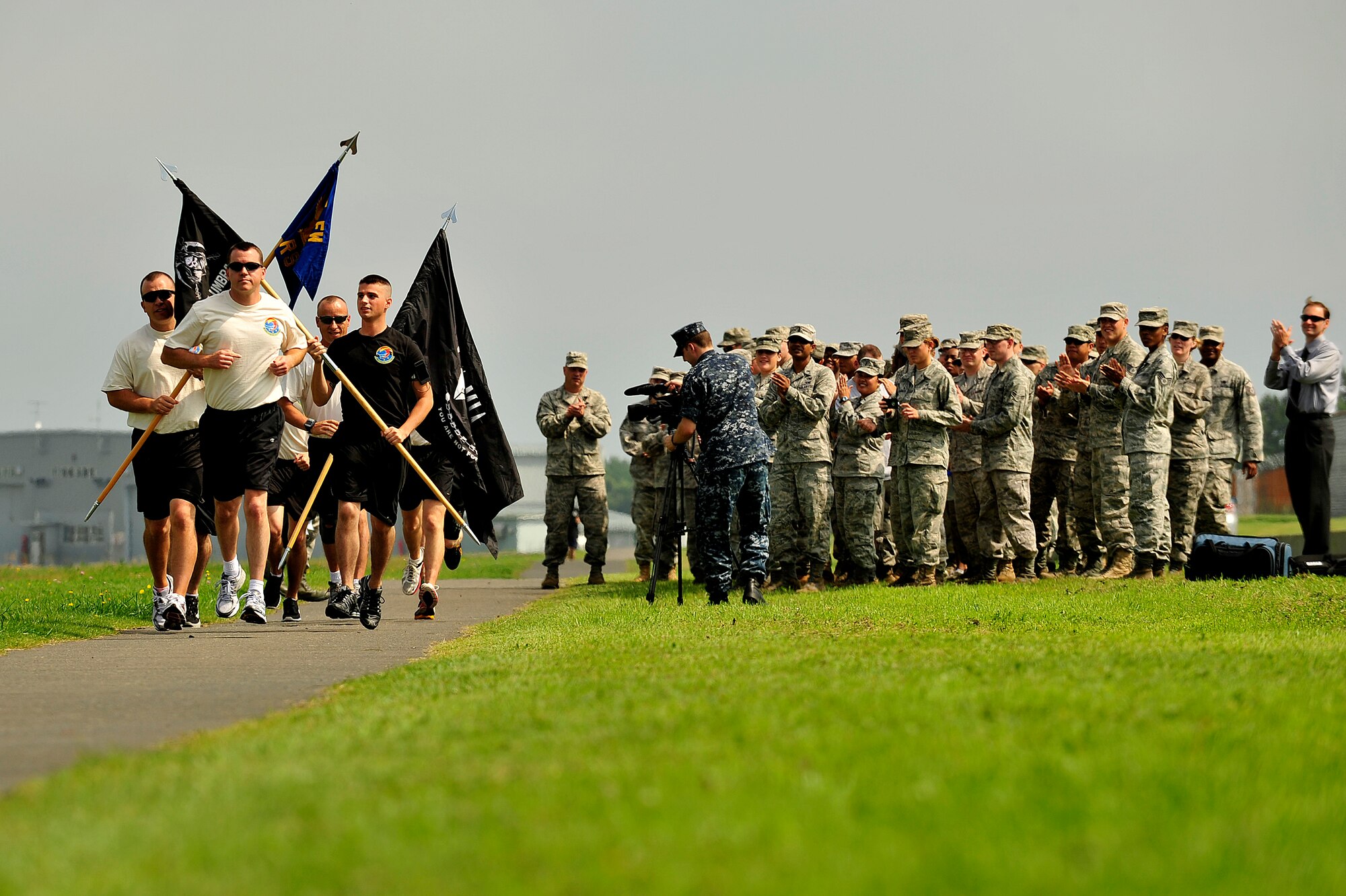 MISAWA AIR BASE, Japan - Members of the 35th Logistics Readiness Squadron, cheer as the first set of runners for the 35th LRS POW/MIA Run take off, Sept. 15. Members of the squadron will run the perimeter of the base for 24 hours in remembrance of prior service members who have gone missing in combat and endured enemy prison camps as part of their sacrifice. (U.S. Air Force photo/Staff Sgt. Nathan Lipscomb)(Released)