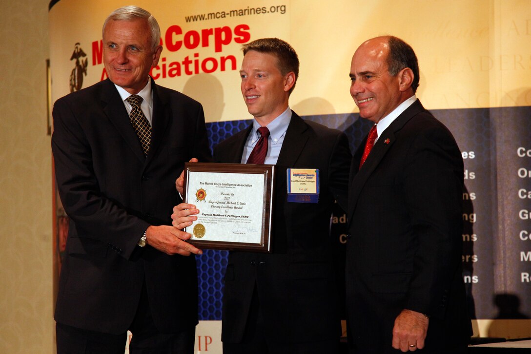 Craig Clarke receives the Mr. John J. Guenther Intelligence Civilian of the Year Award from Gen. Joseph F. Dunford, assistant commandant of the Marine Corps, at the first Marine Corps Association Intelligence Award Dinner Sept. 15, 2011 in Arlington, Va. Four Marines and one civilian were recognized for excellent work in Marine Corps intelligence. The awards are named after Marines who have served the intelligence community.