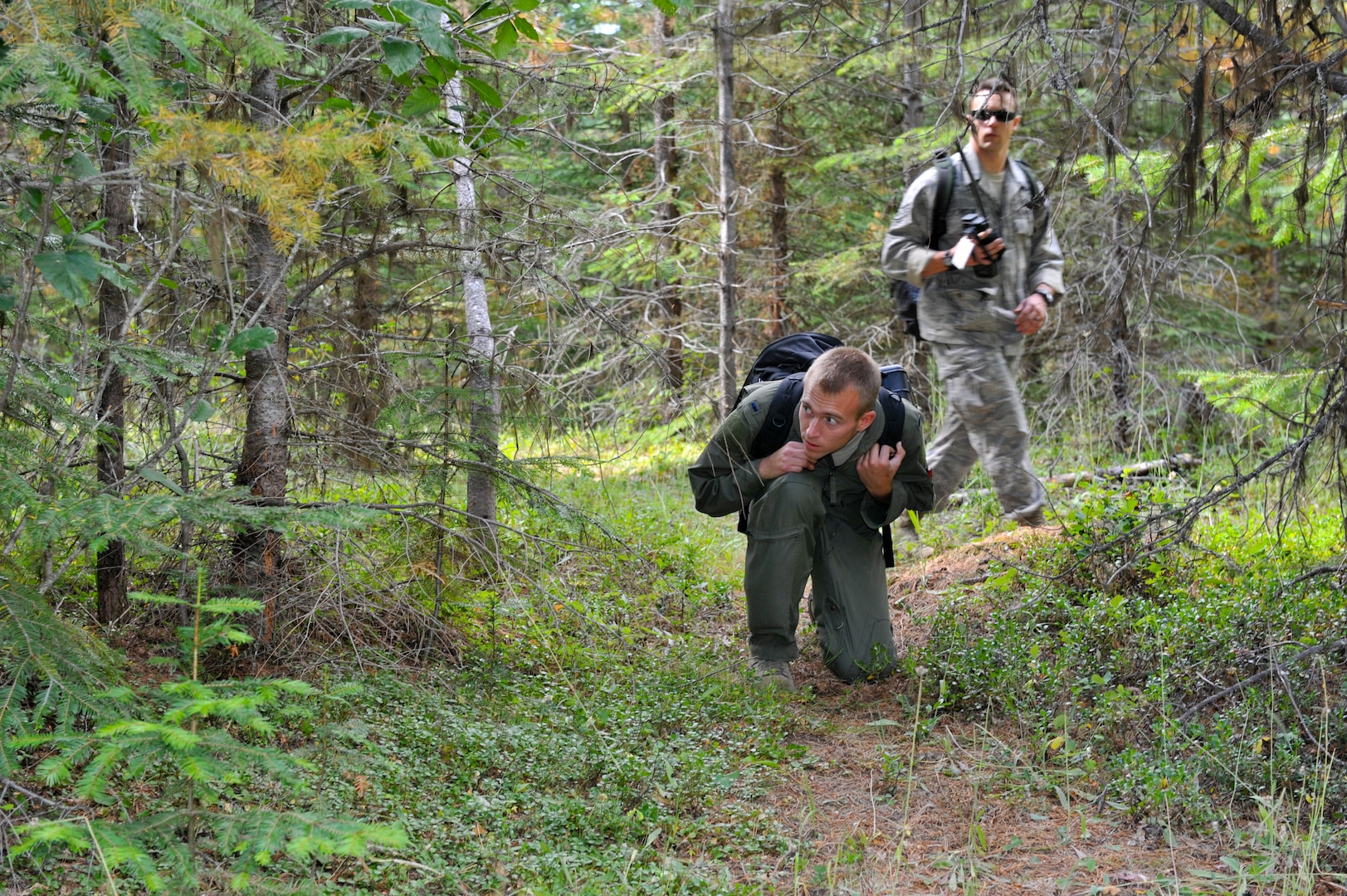 1st Lt. Alexander Denton, 92nd Air Refueling Squadron co-pilot, evades potential enemy threats as Staff Sgt. Justin Reiter, 92nd Operations Support Squadron safety observer, looks on during the On-Scene Commander Exercise Sept. 1 in Ione, Wash. (U.S. Air Force photos/Tech Sgt. J.T. May III)