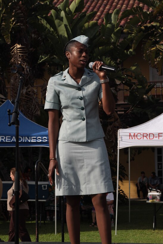 Cpl. Janeisha Taylor, new joins clerk, Headquarters Company, Headquarters and Service Battalion, sings "Amazing Grace" wearing a Marine Corps Uniform from 1967 at the Multicultural Heritage Day event at the Command Museum courtyard aboard Marine Corps Recruit Depot San Diego, Sept. 15.  the four-hour event featured 22 different cultures with performances and information booths.