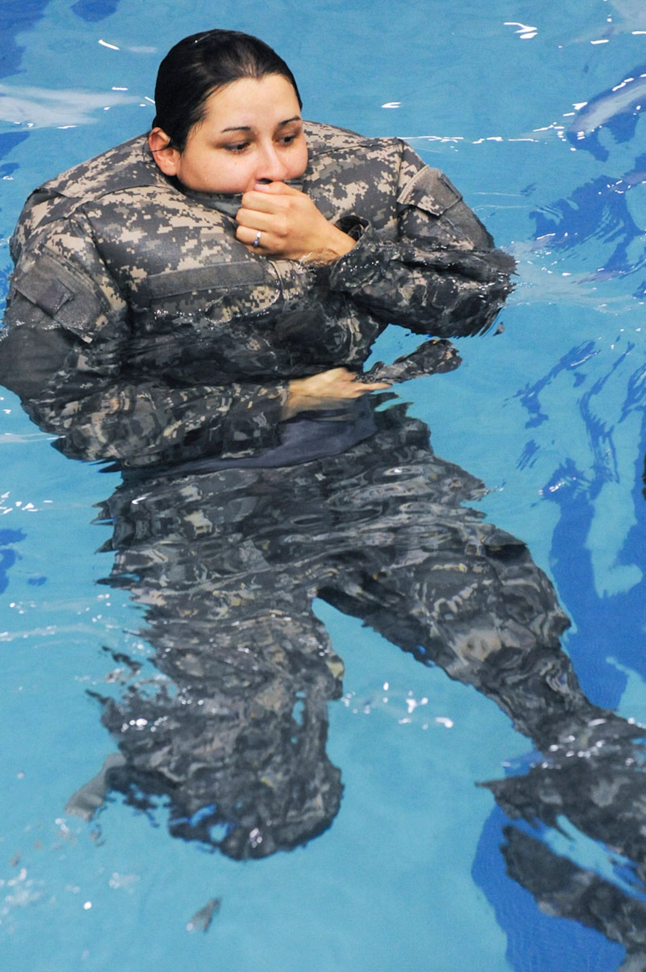 Pvt. Mary Lopez breathes into her Army Combat Uniform to use for flotation.  (U.S. Air Force photo/Percy G. Jones)