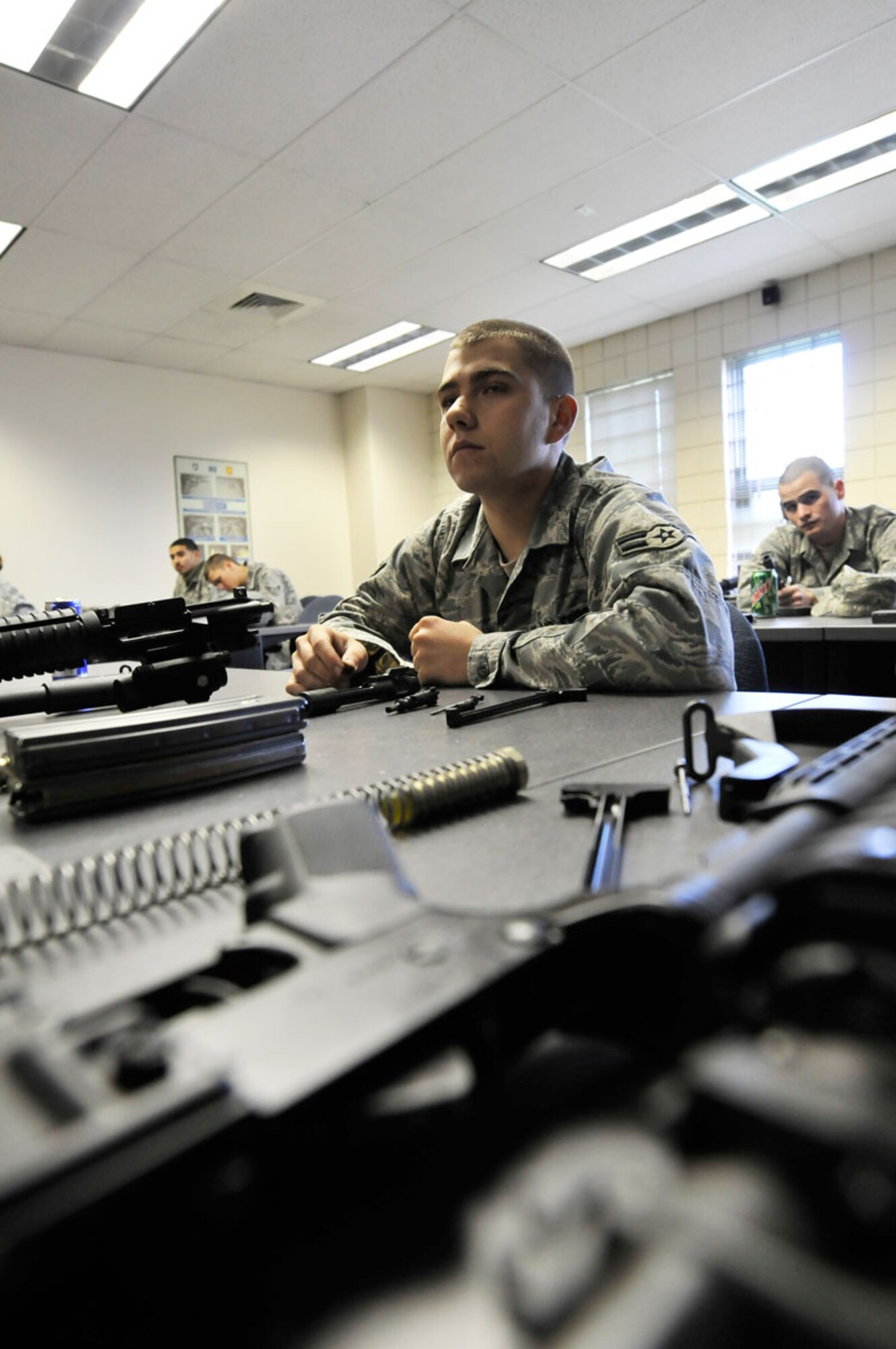 A1C Ross Reynolds, 673 ABW/LRS, Joint Base Elmendorf-Richardson, Anchorage, Alaska, listen on steps to reassemble his weapon during annual weapons training on a M-4A1 carbine. The 7 hour training includes qualifying at the indoor range, weapon handeling, safety,  and weapons cleaning.   (U.S. Air Force photo/Steve White)