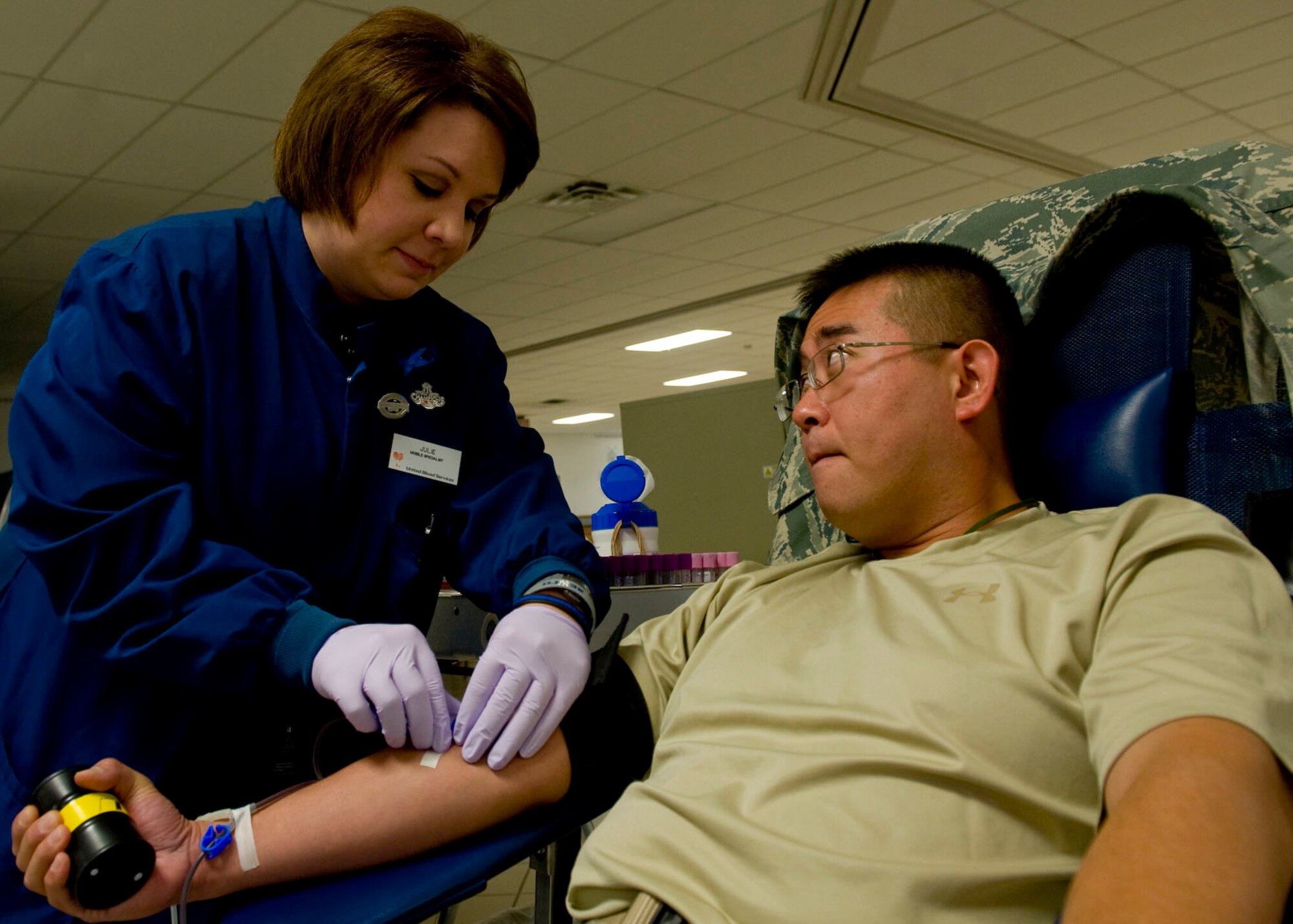 Julie Nollsch, United Blood Services assistant donor care supervisor, inserts a needle into the arm of Staff Sgt. Steve Lee, 28th Operations Support Squadron intellegence plans and programs manager, to draw blood during a blood drive on Ellsworth Air Force Base, S.D., Sept. 16, 2011. United Blood Services uses special blood collection technology to customize the donation process for each donor. (U.S. Air Force photo by Airman 1st Class Kate Thornton/Released)