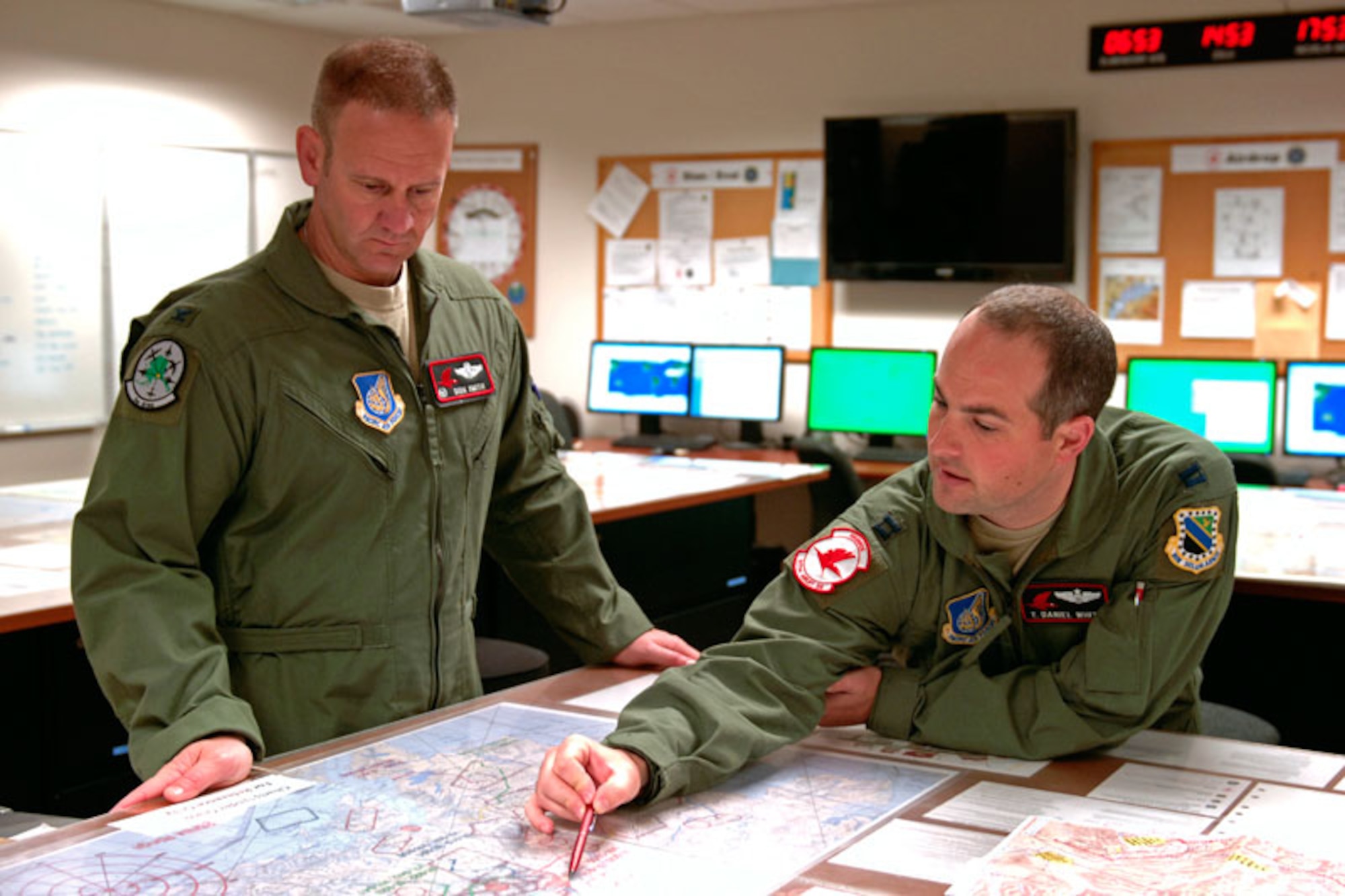 Air Force Col. Dirk Smith, 3rd Wing commander, reviews a map with Air Force Capt. Thomas White before taking a 517th Airlift Squadron C-17 Globemaster III familiarization flight at Joint Base Elmendorf-Richardson, Sept. 7. Smith took command of 3rd Wing Aug. 26. The 517th AS is part of 3rd Wing’s 3rd Group. (U.S. Air Force photo/Staff Sgt. Mark Leahy)