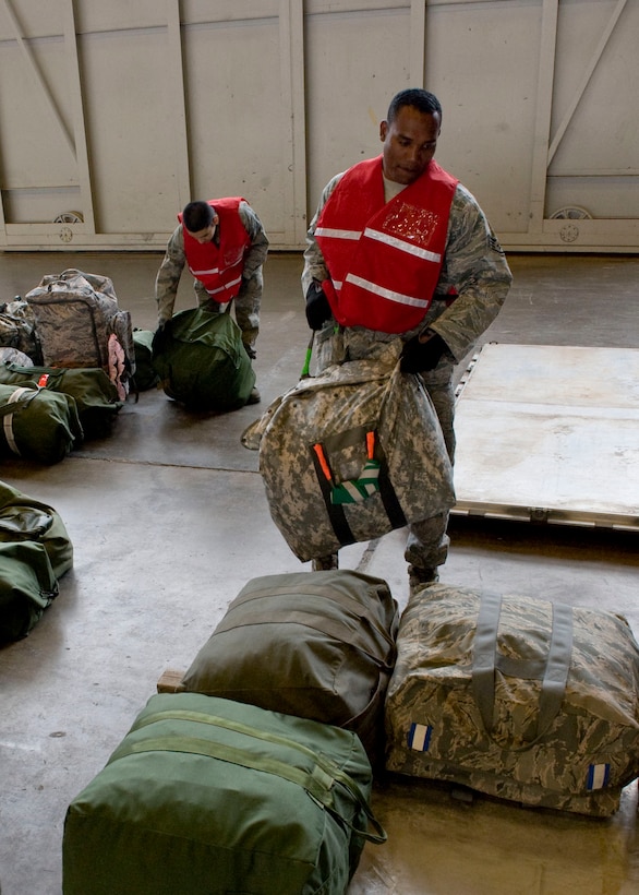 Staff Sgt. Mitchell Harkley (foreground), 28th Medical Operations Squadron aerospace medical technician, and Airman 1st Class Roger Pedraza, 28th MDOS bioenvironmental engineering apprentice, build pallets in the Pride Hangar during an operational readiness exercise on Ellsworth Air Force Base, S.D., Sept. 14, 2011. The purpose of the exercise was to ensure Airmen are trained, prepared and ready to deploy with short notice. (U.S. Air Force photo by Airman 1st Class Kate Thornton/Released)
