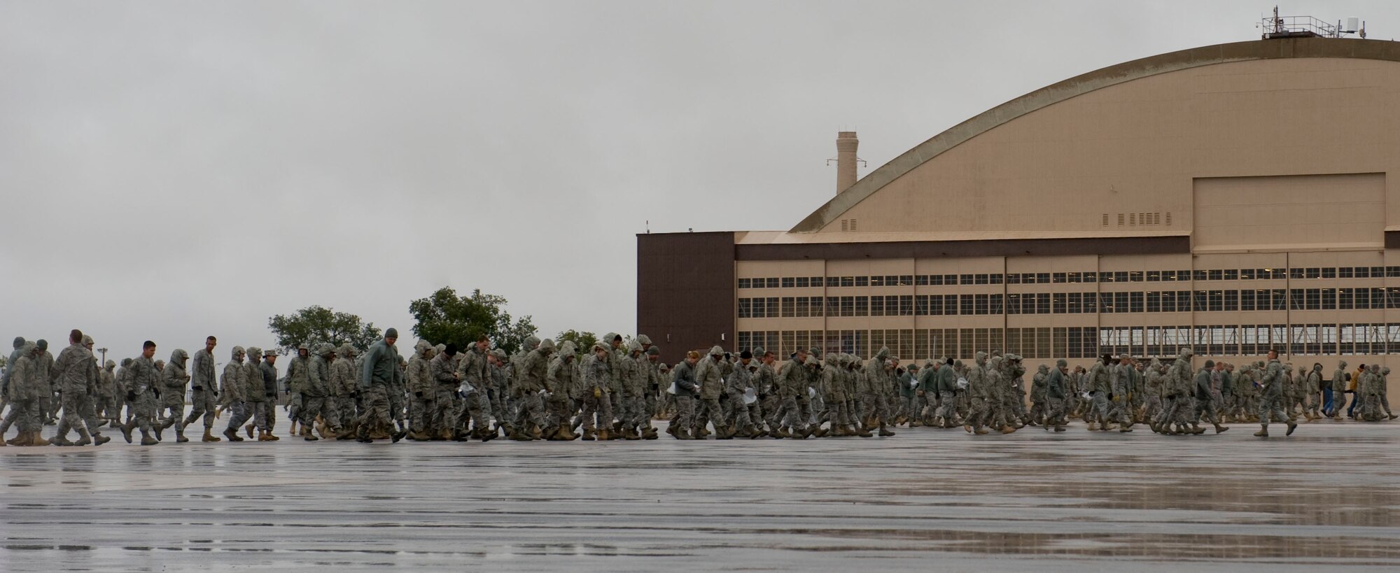 Airmen from the 28th Bomb Wing form a line behind the Pride Hangar during the wing’s Foreign Object Debris walk on Ellsworth Air Force Base, S.D., Sept. 15, 2011. The group was ensuring the runway was FOD free prior to the base B-1s returning from Dyess Air Force Base, Texas. (U.S. Air Force photo by Airman 1st Class Kate Thornton/Released)