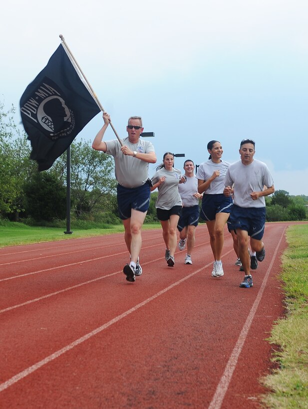 Airman honor our nations prisoners of war and missing in action by in a 24-hour Run/Walk Vigil at Langley Air Force Base, Va., Sept. 16, 2011. The POW/MIA flag was transported by various volunteers around the base through the night, arriving at the memeorial to begin the official POW/MIA ceremony. (U.S.  Air Force photo by Staff. Sgt. Antoinette Gibson/Released)
