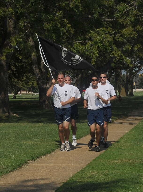 Airmen sprint along the Shellbank Fitness Center track during the POW/MIA 24-hour Run/Walk Vigil at Langley Air Force Base, Va., Sept. 16, 2011. More than 350 runners participated in the annual event, which is now in its second year. (U.S.  Air Force photo by Staff. Sgt. Antoinette Gibson/Released)
