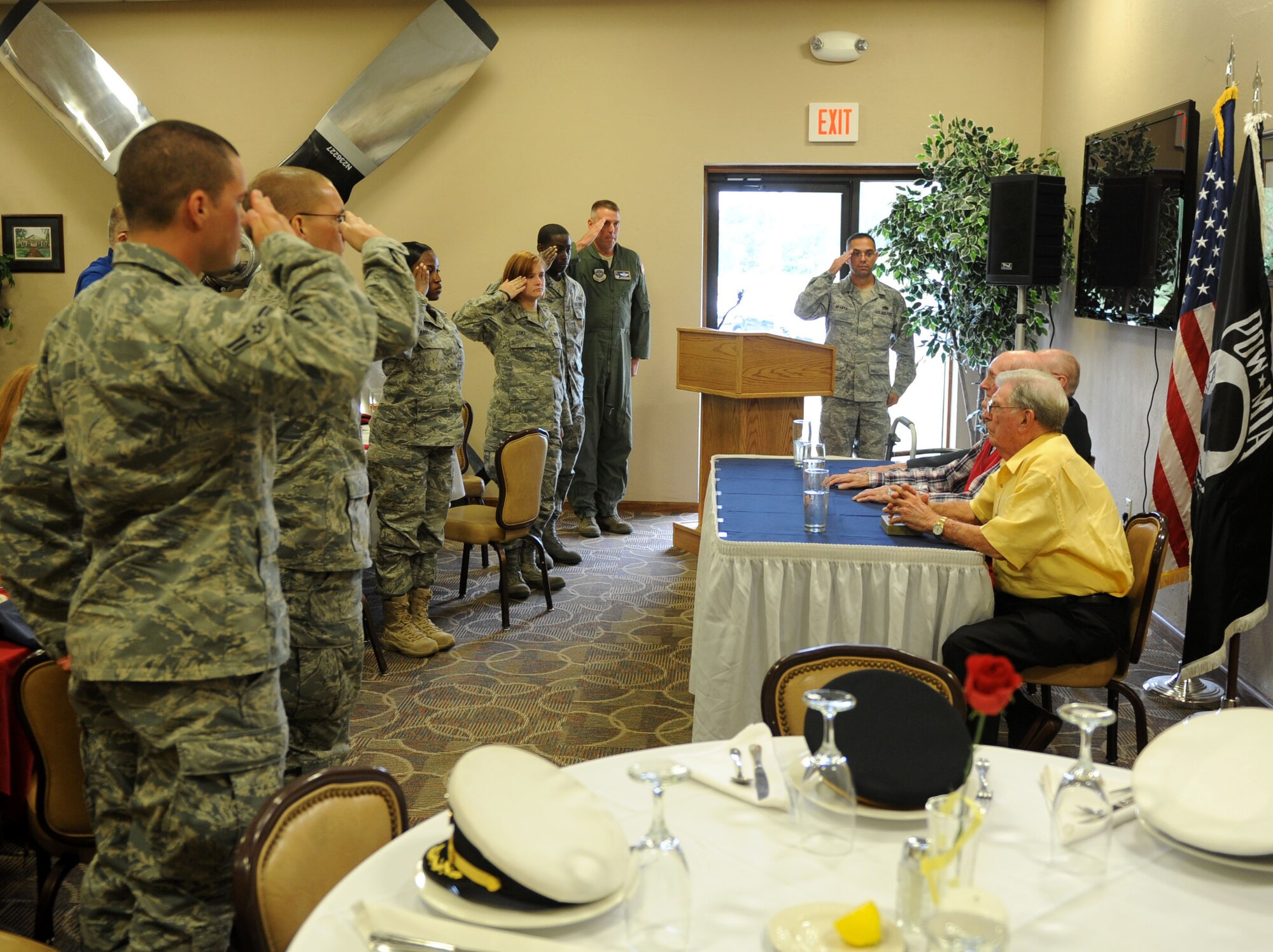 Team Little Rock members render a salute during a luncheon at Hangar 1080 for the National Prisoner of War/Missing in Action Recognition Day today at Little Rock Air Force Base, Ark. National POW/MIA Recognition Day was first observed in 1980, and it is traditionally observed on the third Friday of September. (U.S. Air Force Photo by Senior Airman Caleb Pierce)