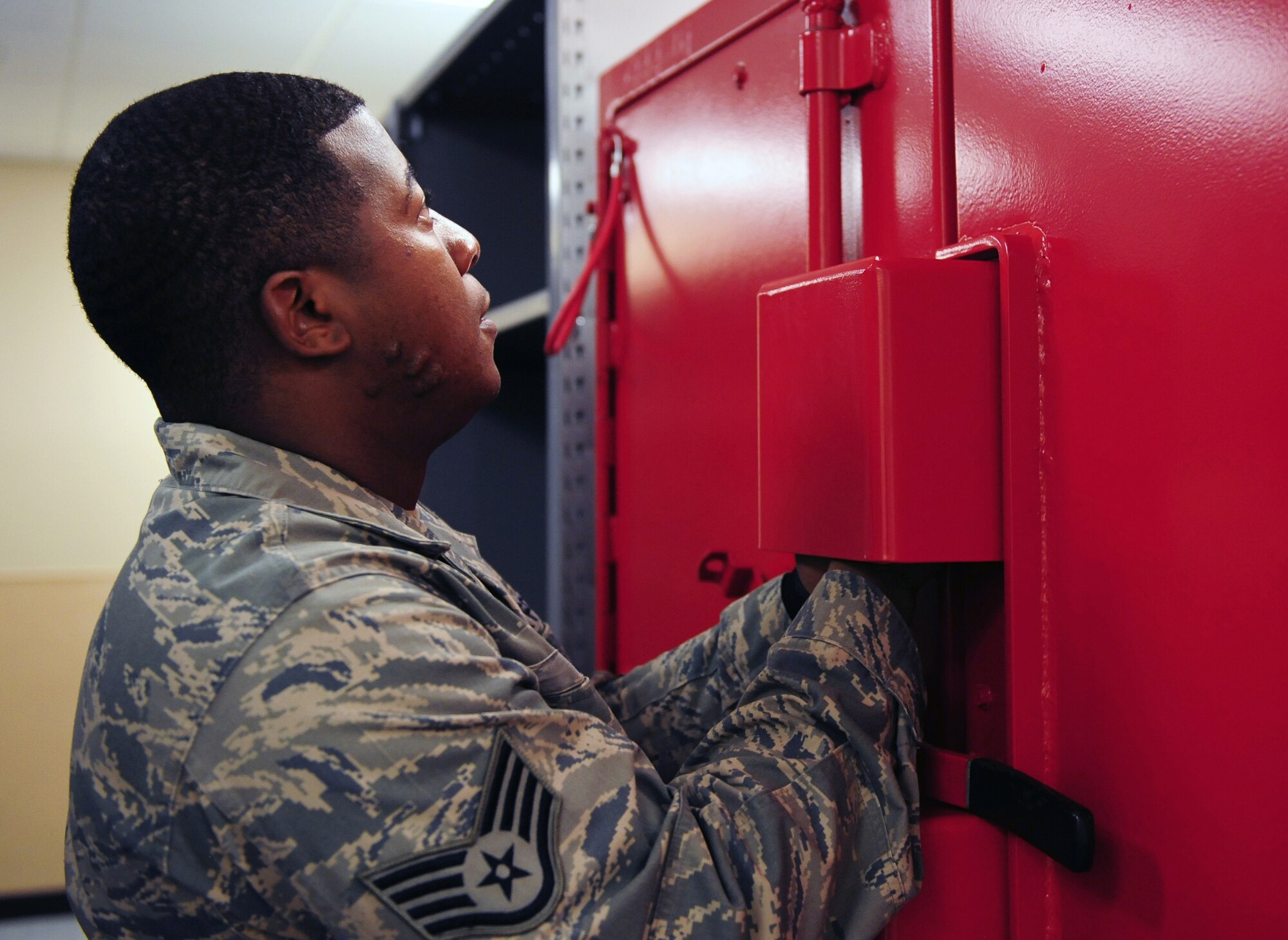 Staff Sgt. Sherman Smith, 2nd Security Forces Squadron, opens a locker in the new 2 SFS building on Barksdale Air Force Base, La., Sept. 15. Smith inspected the explosives cabinet at the new 2 SFS facility which is located near the softball fields off of Range Road. (U.S. Air Force photo/Airman 1st Class Benjamin Gonsier)(RELEASED)