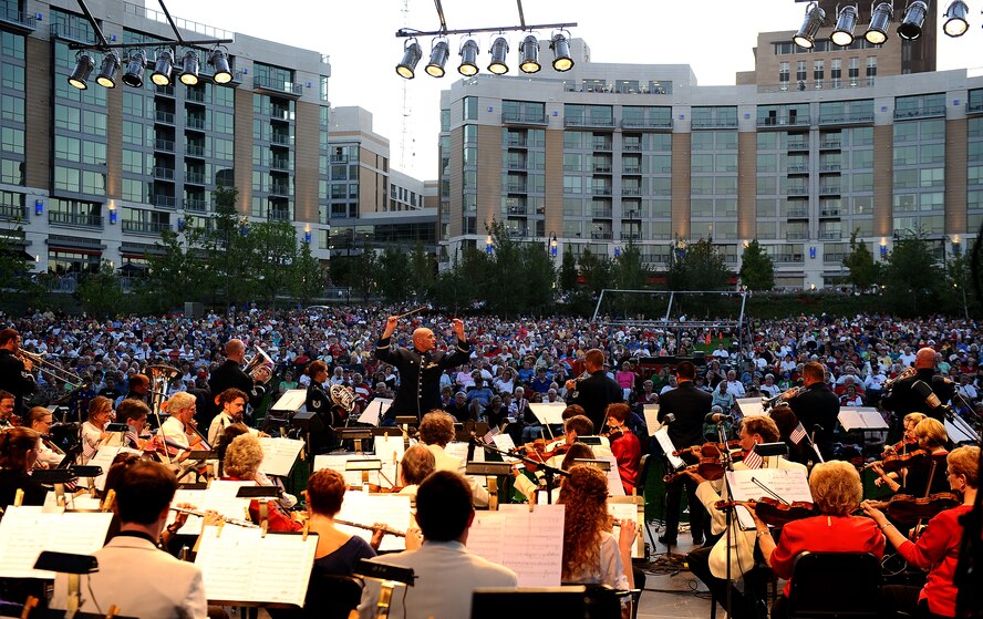 U.S. Air Force Capt. Michael D. Hoerber, U.S. Air Force Heartland of America Band commander and conductor, leads the Omaha Symphony and the Brass in Blue ensemble in a 9/11 memorial concert held at Turner Park in Omaha, Neb.,  Sept. 11.  The A Celebration of American Spirit concert drew in a crowd of more than 9,000 people. (U.S. Air Force photo by Josh Plueger/Released)