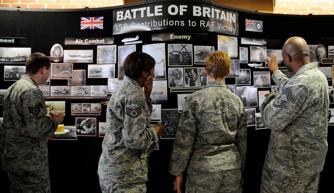Members of the 480th Intelligence, Surveillance and Reconnaissance Wing, look at visual displays during the Battle of Britain Observance ceremony Sept. 15, 2011 at Langley Air Force Base, Va. The ceremony included posting of the colors, the national anthems for United States and Great Britain, a brief history of the battle and a reception for those in attendance. (U.S. Air Force photo by Staff Sgt. Dana Hill/Released)