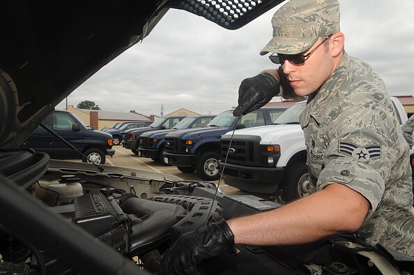 Senior Airman Jim McKibben, 2nd Logistics Readiness Squadron vehicle operator, checks the oil and transmission fluid levels on a truck in the vehicle yard by the vehicle operations facility on Barksdale Air Force Base, La., Sept. 15. Before and after driving any government vehicle a checklist is run to check for minor maintenance and safety issues. (U.S. Air Force photo/Senior Airman Kristin High)(RELEASED)