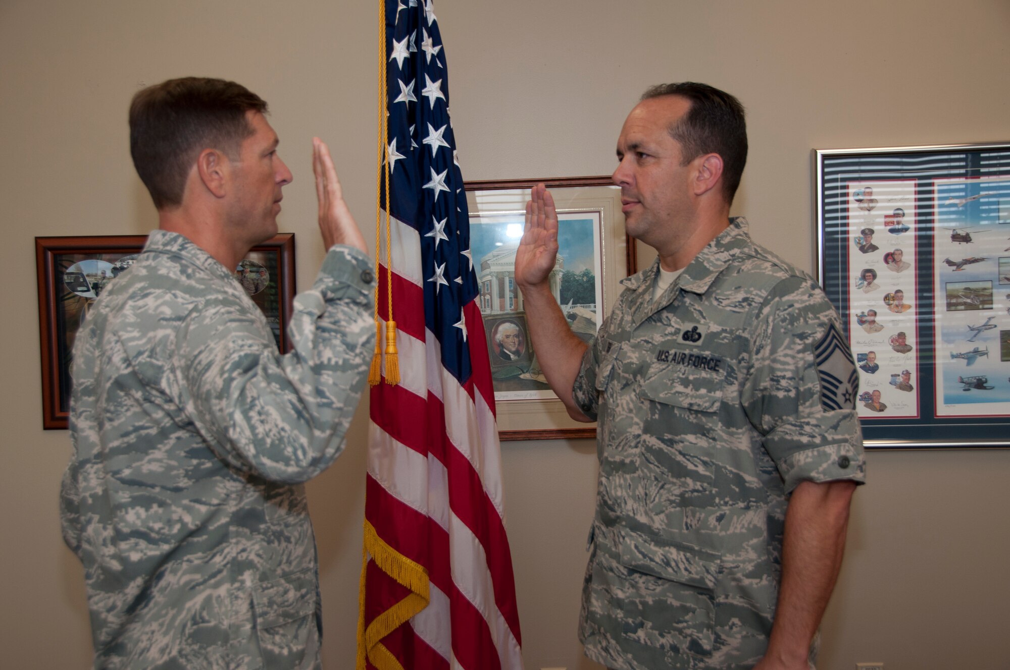 Chief Master Sgt. David Fish recites the oath of enlistment for the final time in a ceremony presided by Col. Thomas Joyce, commander, Air Force Mortuary Affairs Operations, Sept. 9, 2011 at the Charles C. Carson Center for Mortuary Affairs at Dover Air Force Base, Del. Fish is the chief enlisted manager for AFMAO. (U.S. Air Force Photo/Staff Sgt. Agustin Salazar)