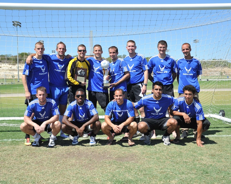 The Patrick AFB varsity soccer team, minus some members due to injuries, celebrates winning the Air Force Defender's Cup over Labor Day weekend at Lackland AFB, Texas. Goalkeeper Airman 1st Class Jon Olson received the Top Defender award for allowing no goals against.