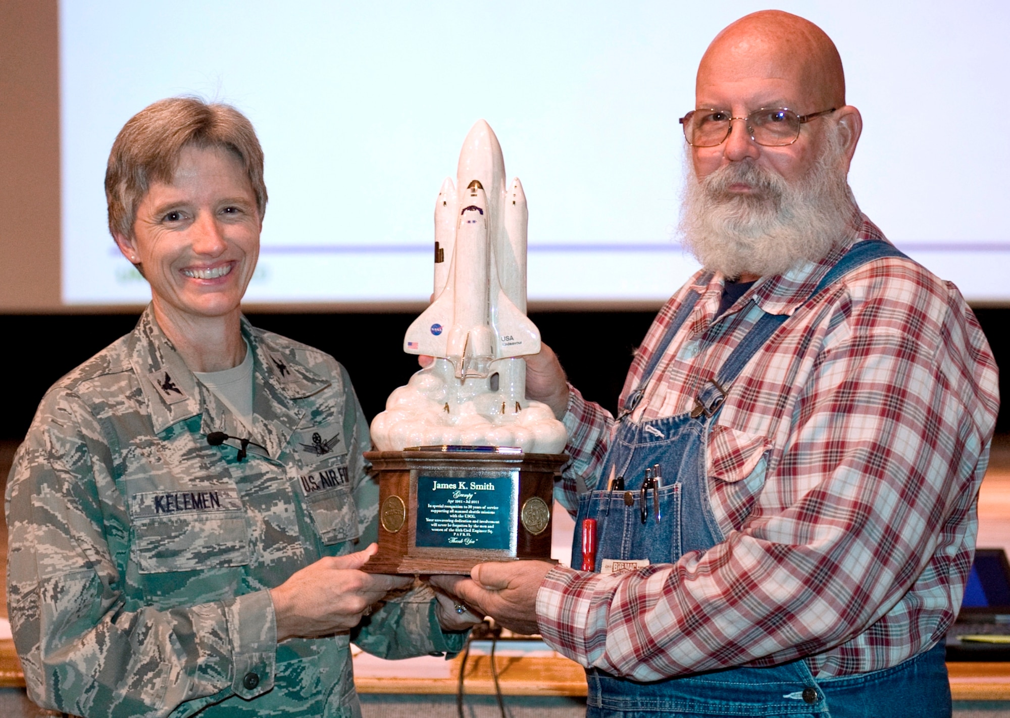 Col. Loretta Kelemen, 45th Mission Support Group commander, presents James “Grumpy” Smith, 45th Civil Engineer Squadron, with a model of Space Shuttle Endeavor during an Aug. 30 ceremony at Patrick AFB. Mr. Smith was honored for his 30 years of continuous service to the shuttle program.