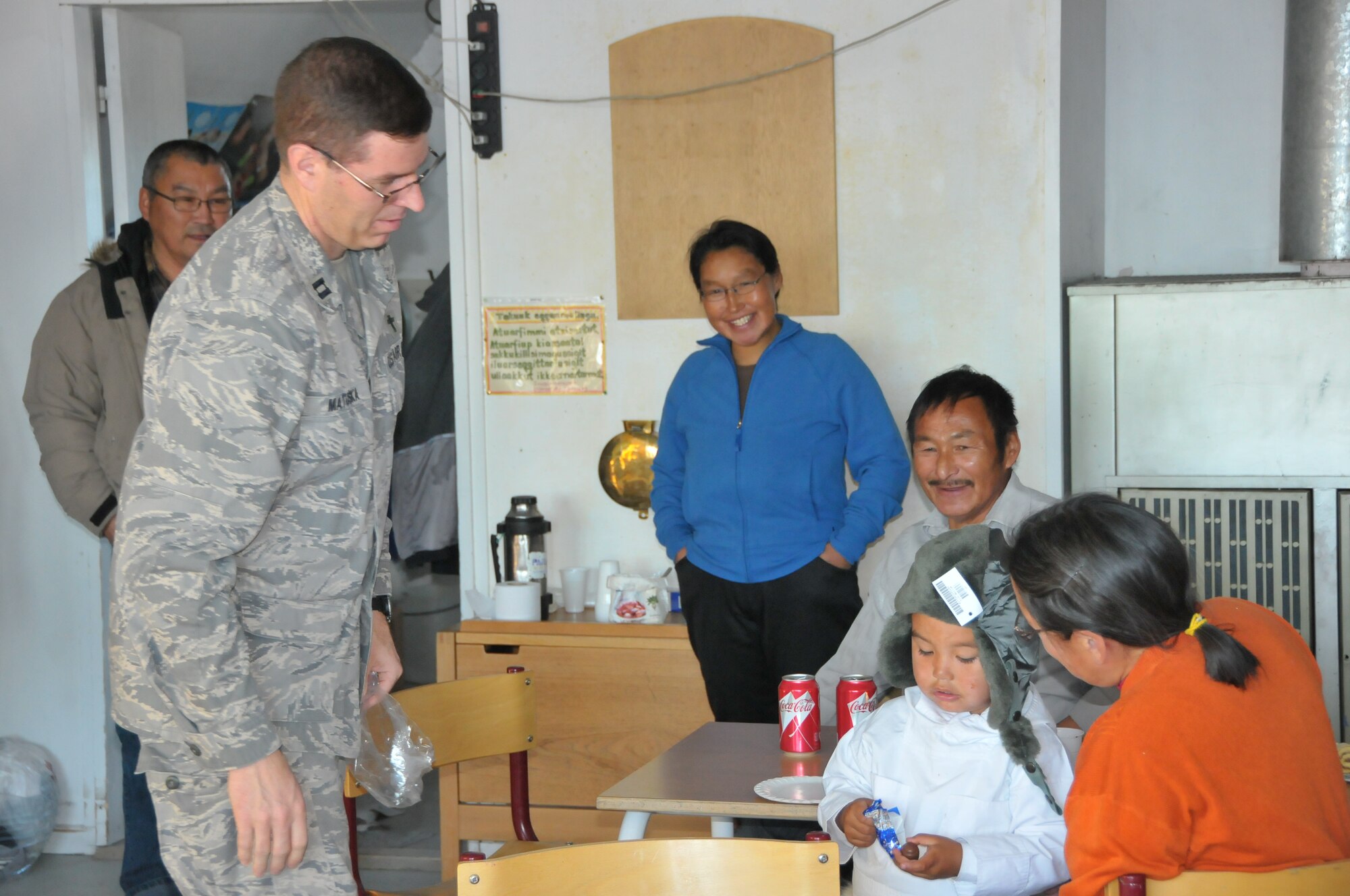 Chaplain (Capt.) Wade Matuska, 821st Air Base Group chaplain, checks out the fit of a warm winter hat. The hat was among the many clothes donated by Thule Air Base personnel as part of its Operation Julemand, an annual holiday fundraiser at Thule to benefit area children. (Photo courtesy Jan Olsen)