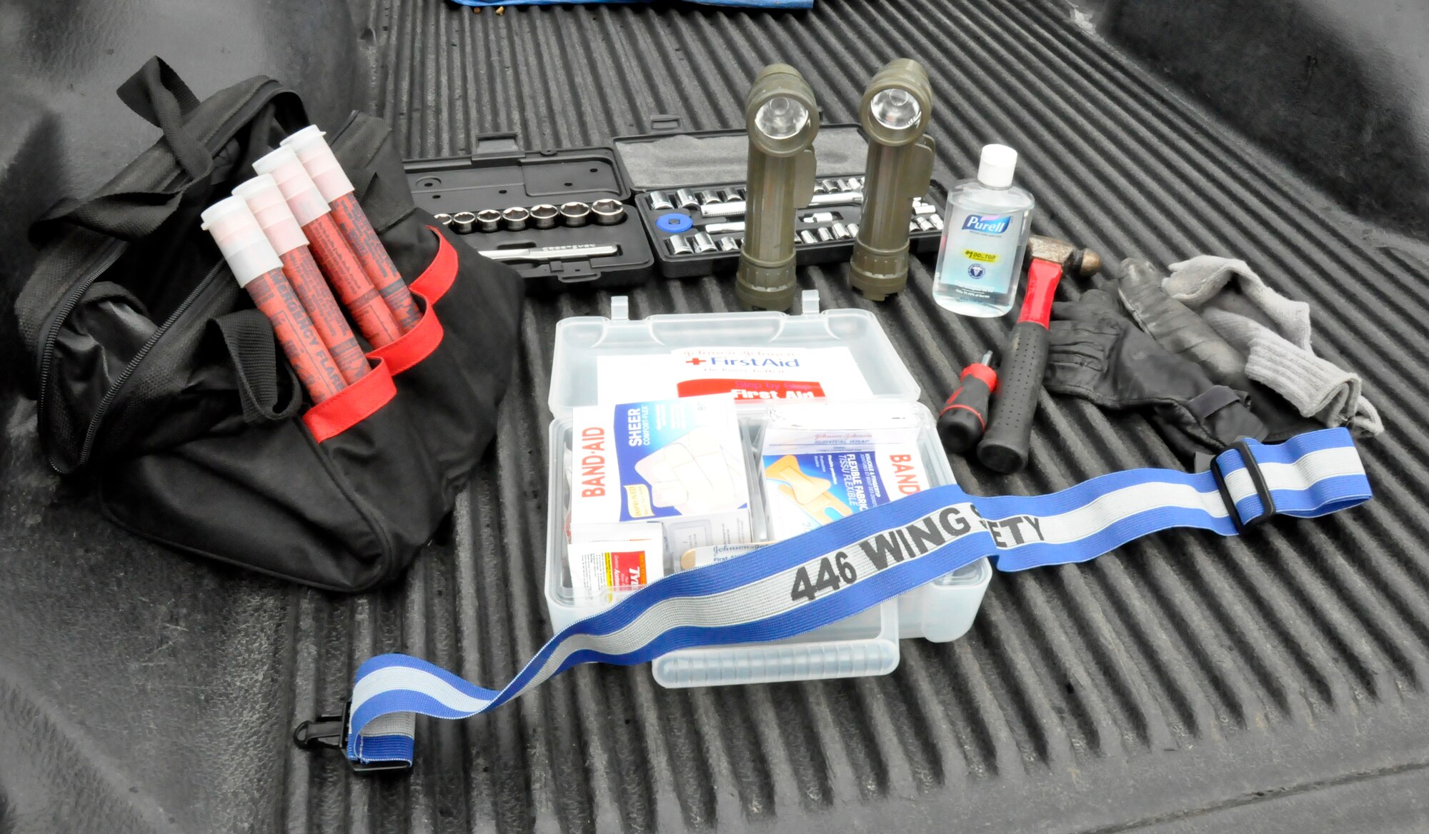 An emergency supply kit for personal automobiles is displayed with some of the basic items suggested in the case of vehicle accidents, being stranded in bad weather or remote locations, vehicle breakdowns, long-distance travel, or helping others who need assistance. The 446th Airlift Wing Safety Office, McChord Field, Wash. staff recommends kits like these be stored in a backpack for easier mobility. (U.S. Air Force photo by Master Sgt. Jake Chappelle) 
