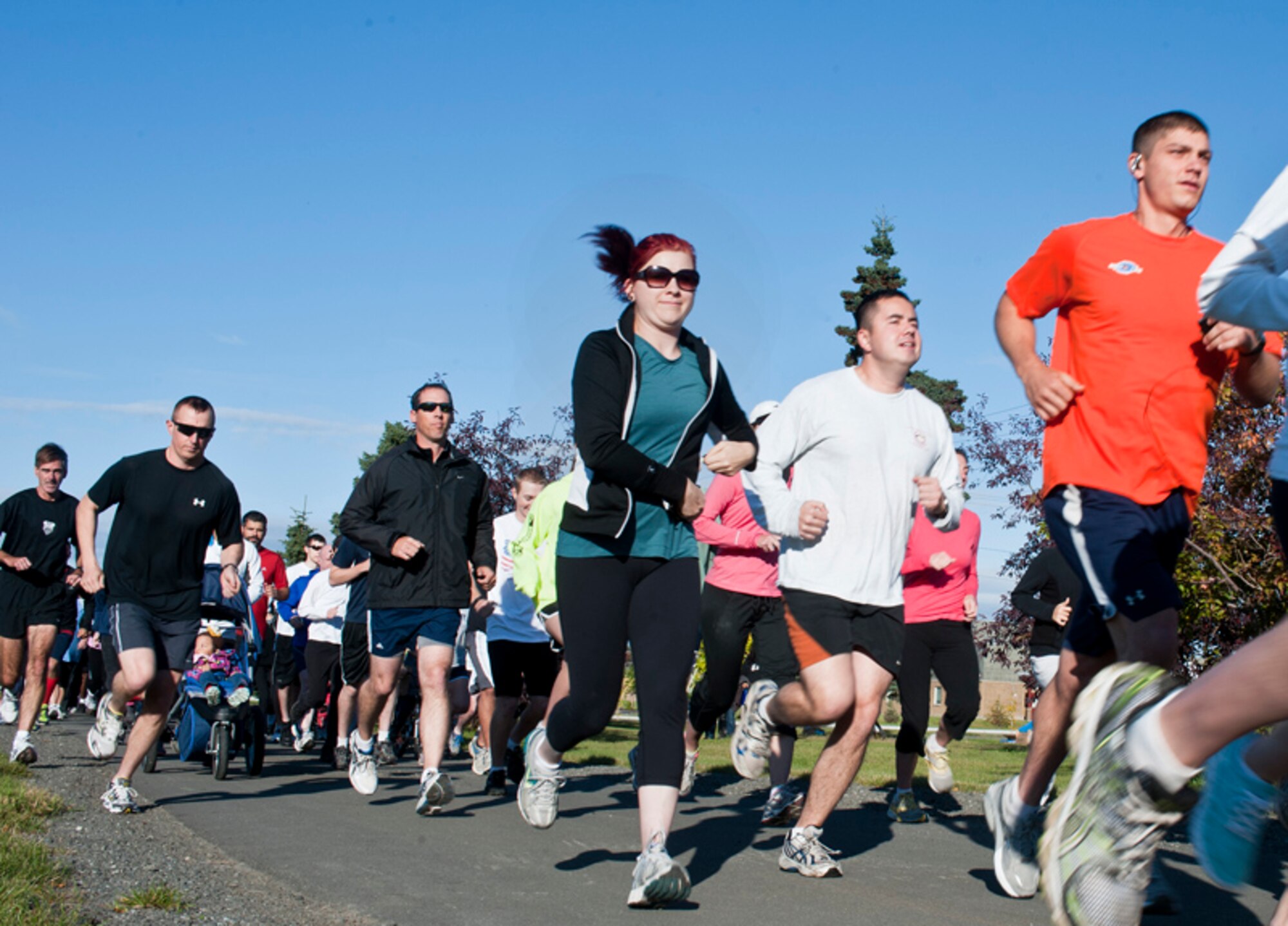 Participants in the Patriot Run begin the 5K memorial run on JBER at the bike
path across from the Buckner Physical Fitness Center Sunday. The run was in honor of those who lost their lives on September 11, 2001. (U.S. Air Force photo/Staff
Sgt. Zachary Wolf) 